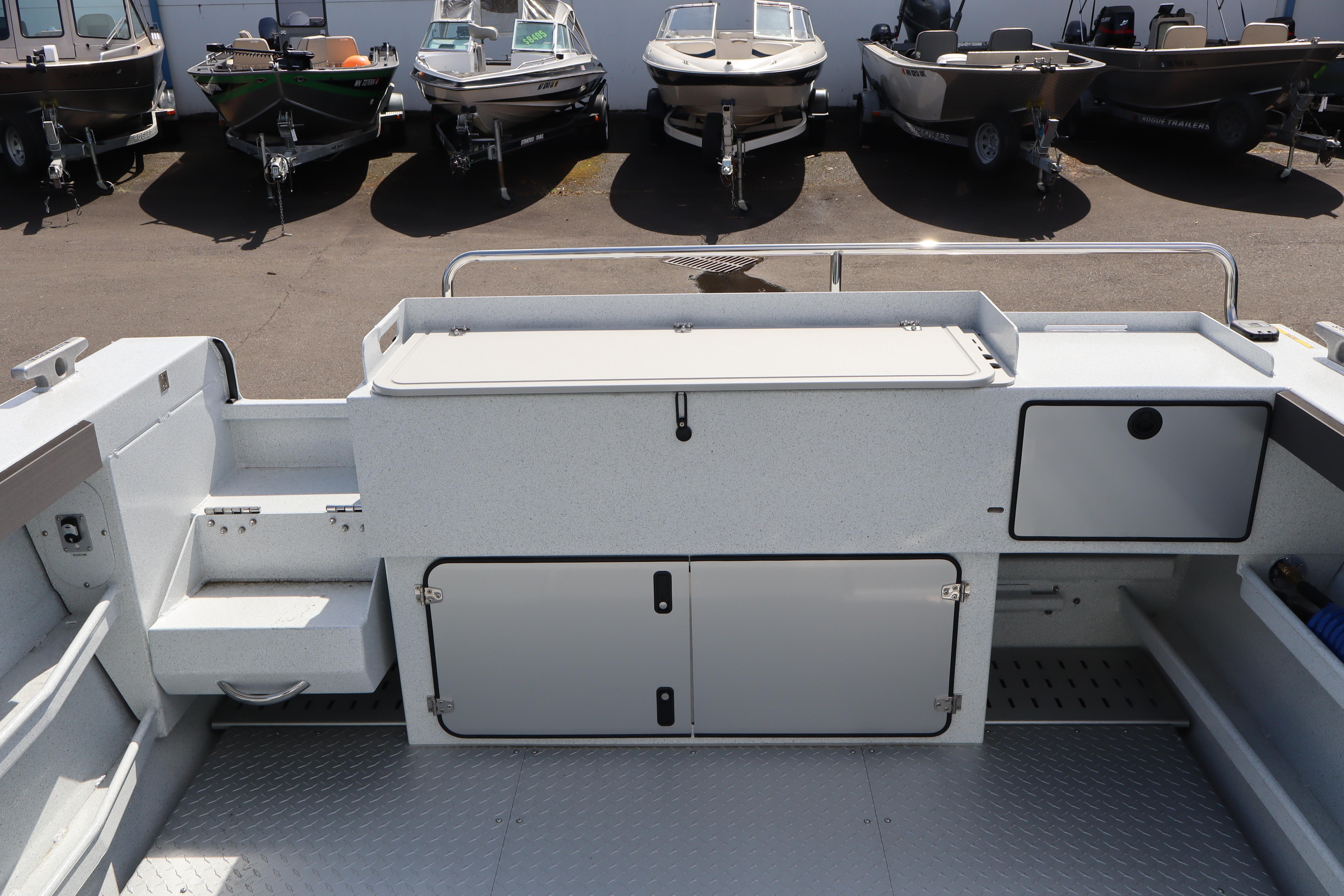 2026 KingFisher 2425 Escape HT boat interior with storage compartments and seating.