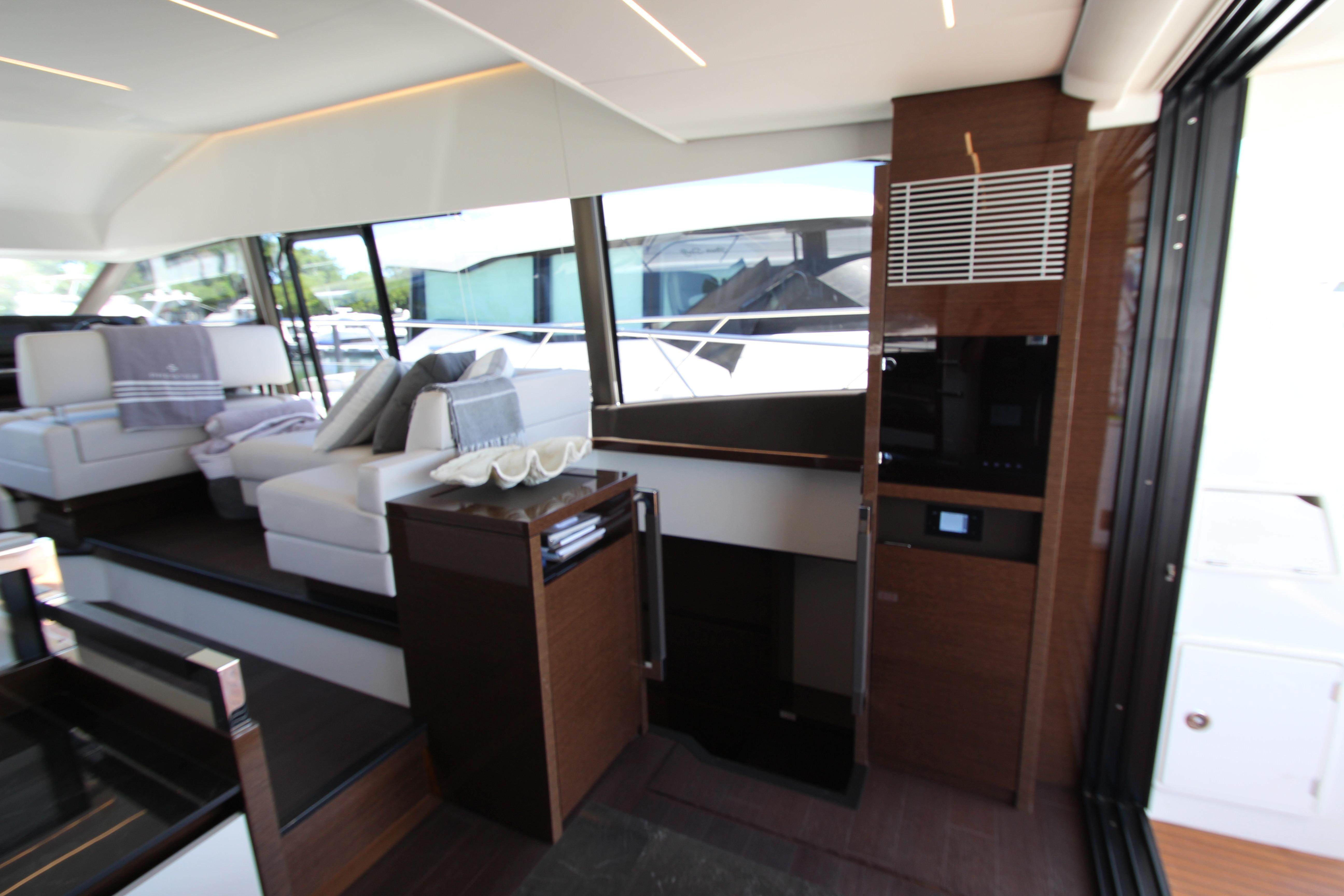 Luxurious interior of 2022 Prestige 520 yacht with modern seating and sleek design.