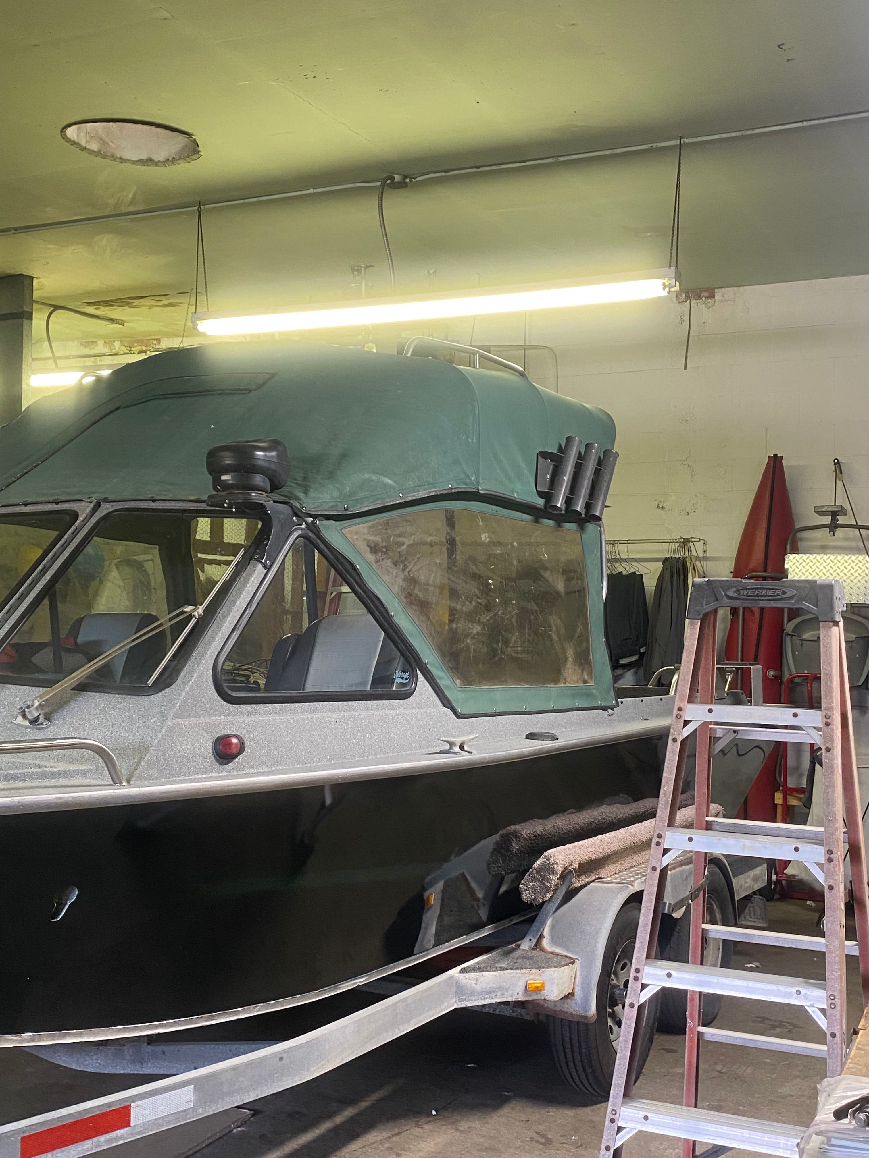 1993 Jetcraft Fastwater boat in a workshop on a trailer.