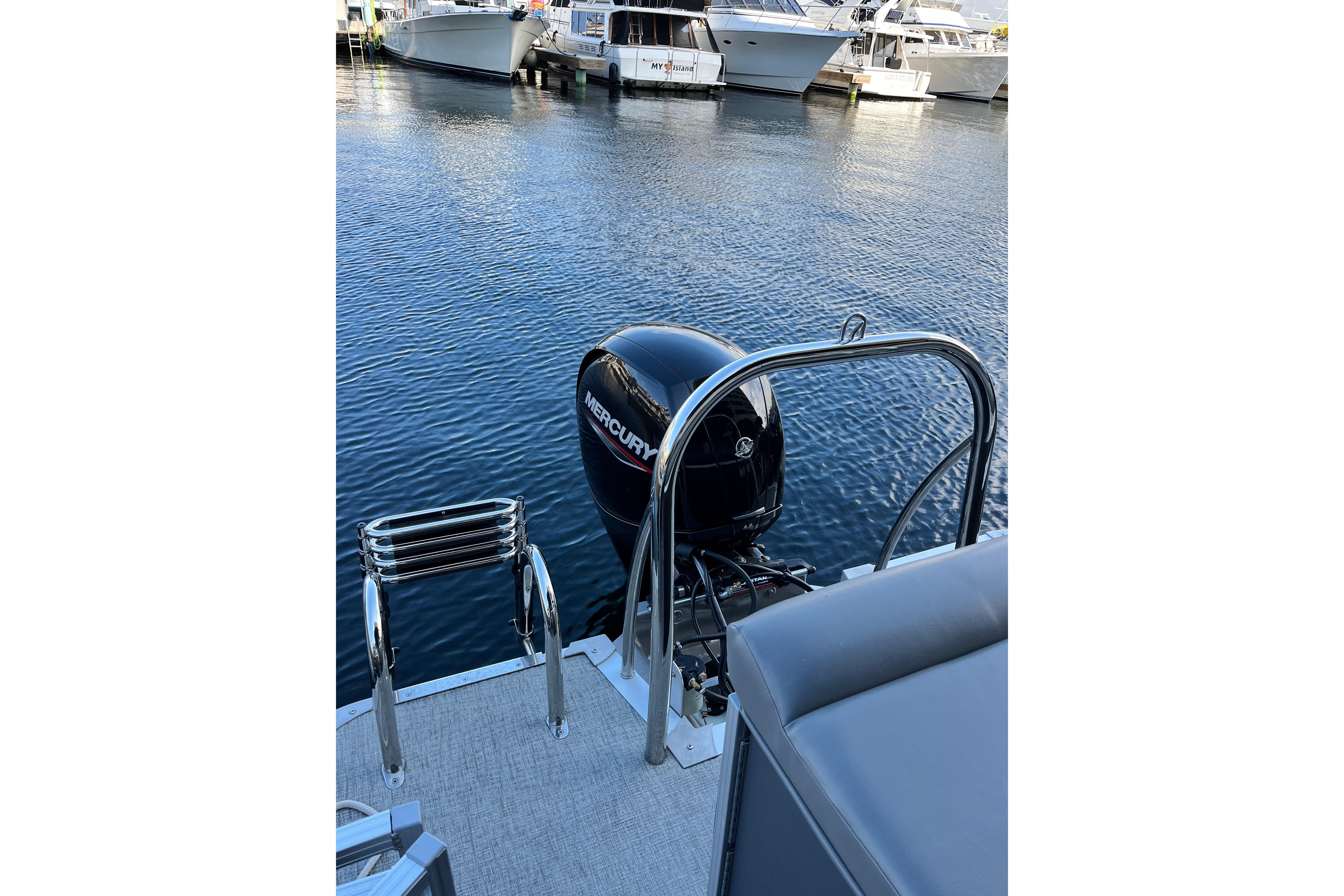 2023 Tahoe Pontoon LTZ Cruise with Mercury outboard motor at marina.