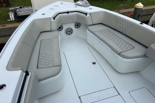 2023 Contender 32 ST boat interior with cushioned seating and speakers.