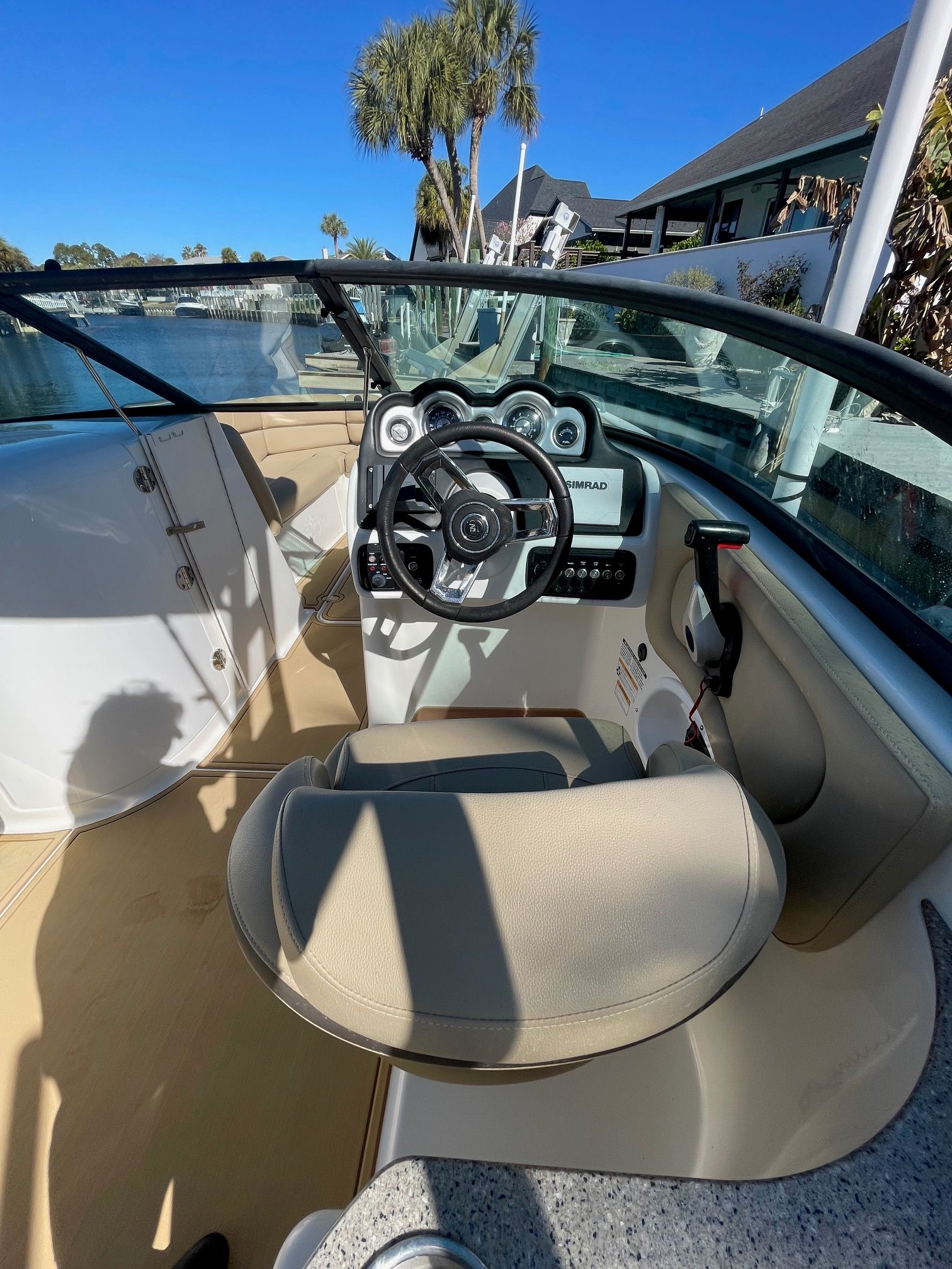 2019 NauticStar 243DC Sport Deck boat with modern cockpit and beige seating.
