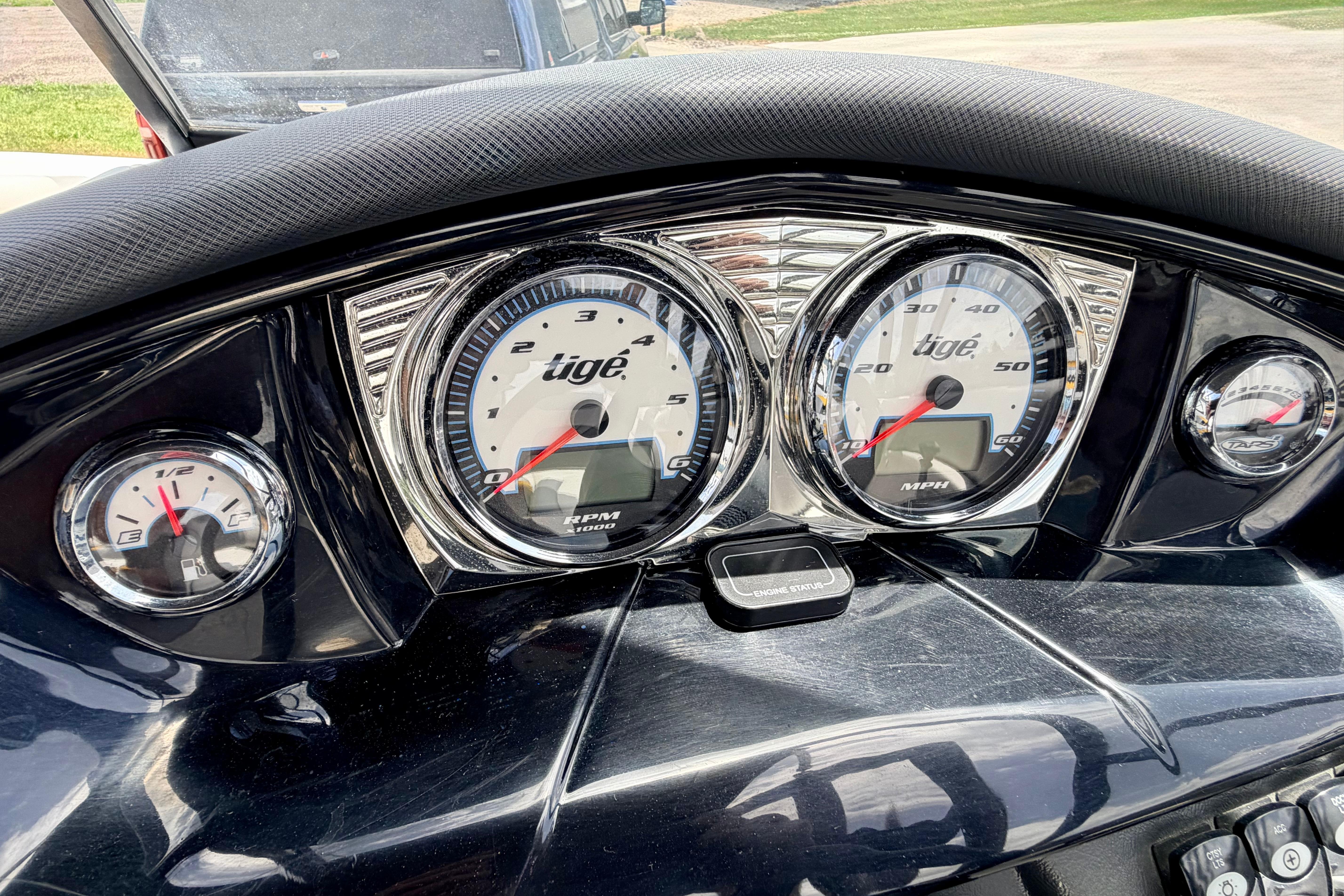 Dashboard of a 2014 Tigé R20 boat with speedometer and tachometer gauges.