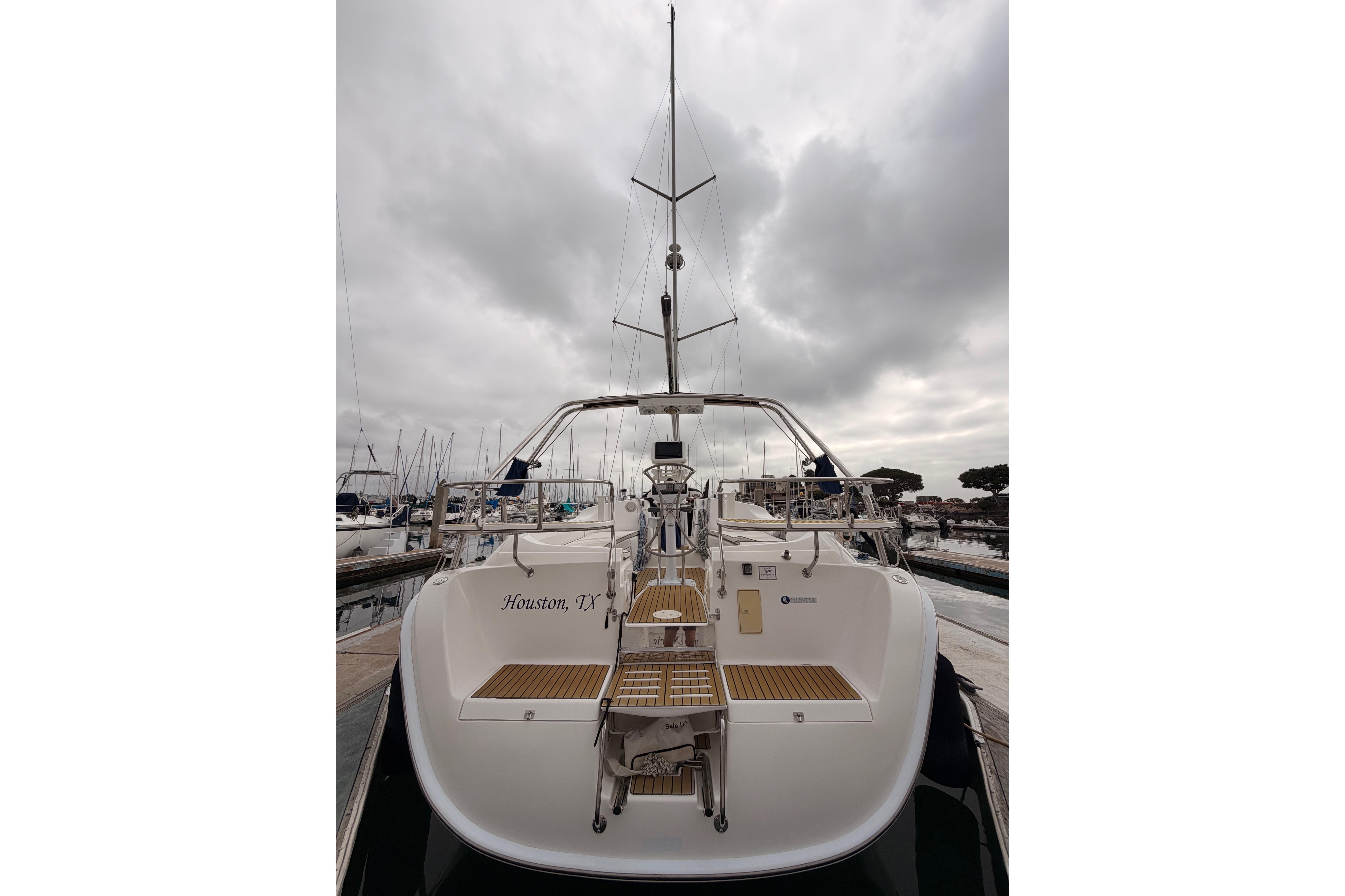 Sailboat docked under cloudy skies, Hunter 38 model, 2009, Houston, TX.