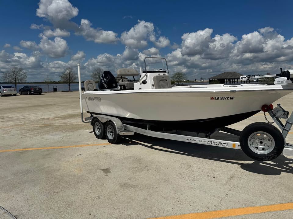 2022 Sea Pro 199 Center Console on trailer, parking lot, cloudy sky.