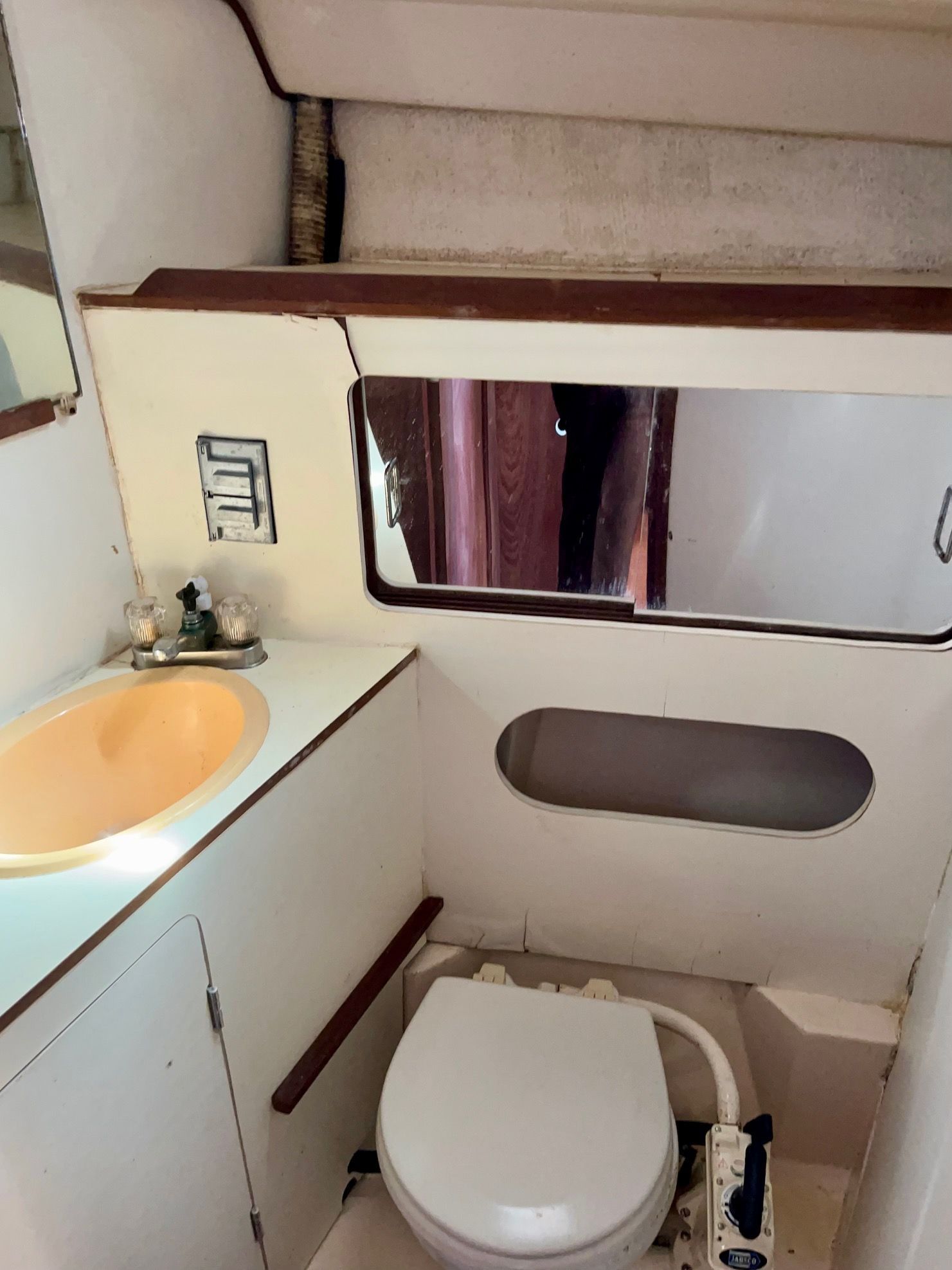 The image shows the bathroom of a 1985 Hunter 30 with a sink and toilet.