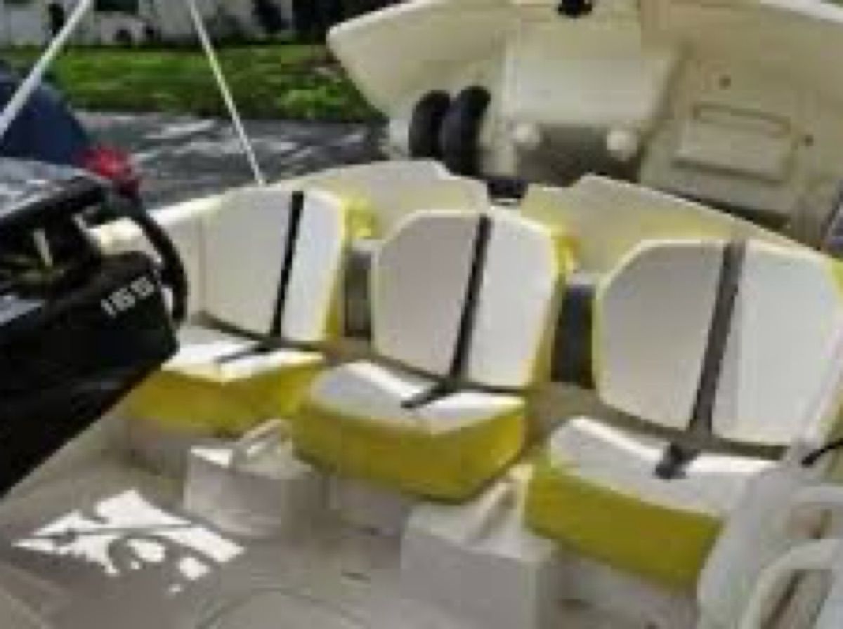 The image shows the interior of a 2017 Scarab 165 G boat with yellow and white seats.