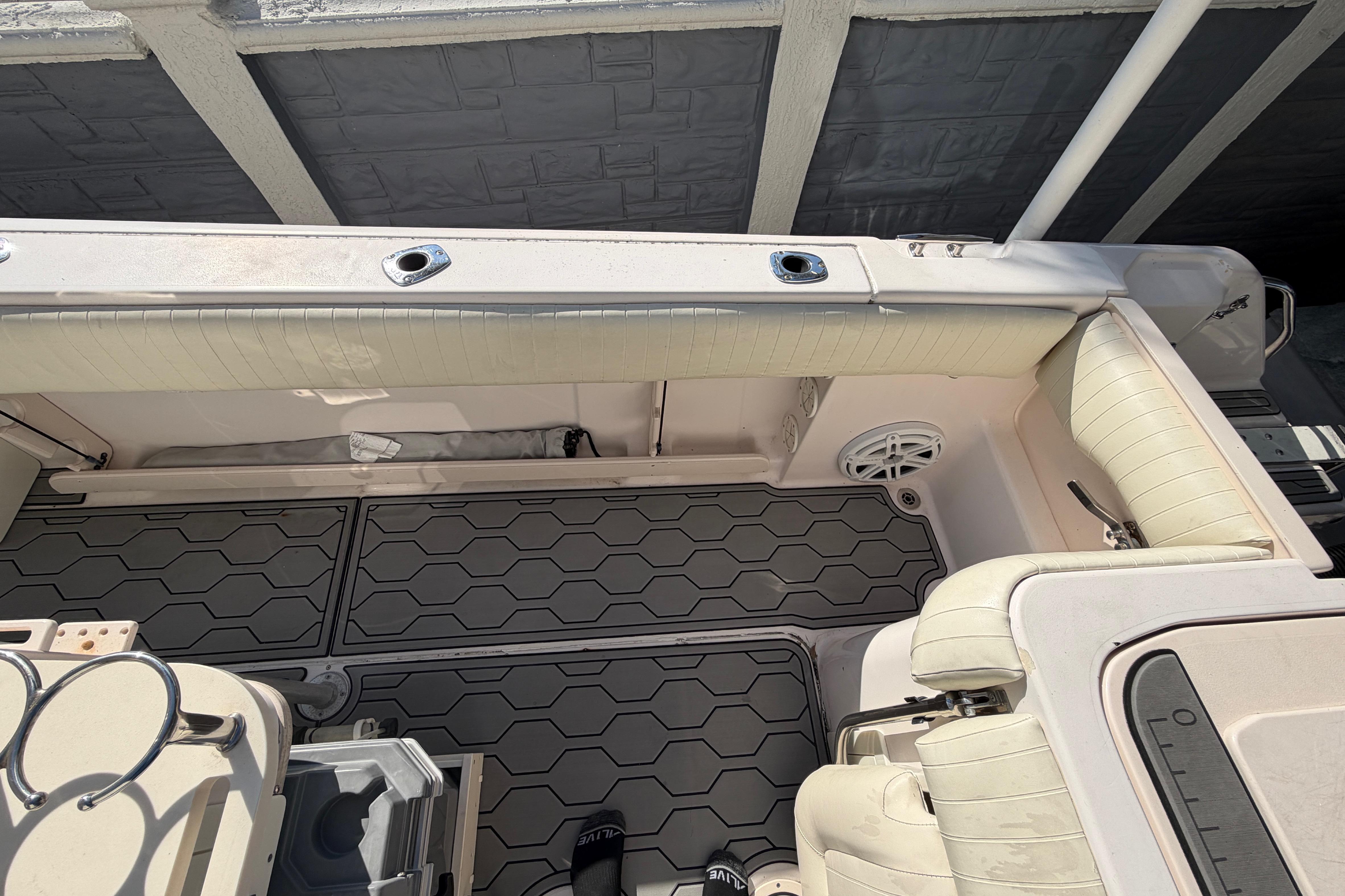 2004 Grady White 273 boat interior with cushioned seating and hexagonal floor design.