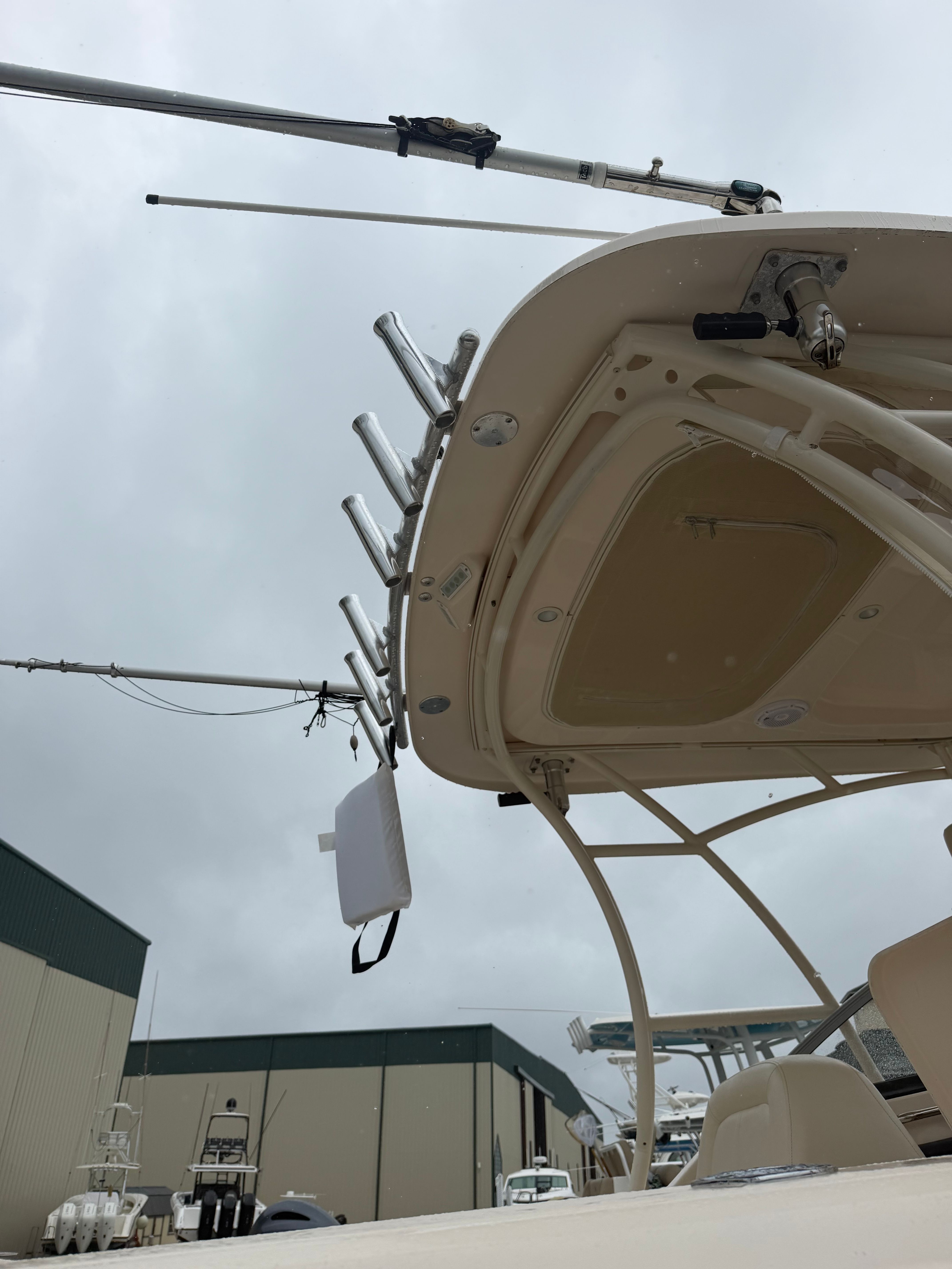 A 2015 Grady-White Freedom 275 boat with fishing rod holders and a T-top.