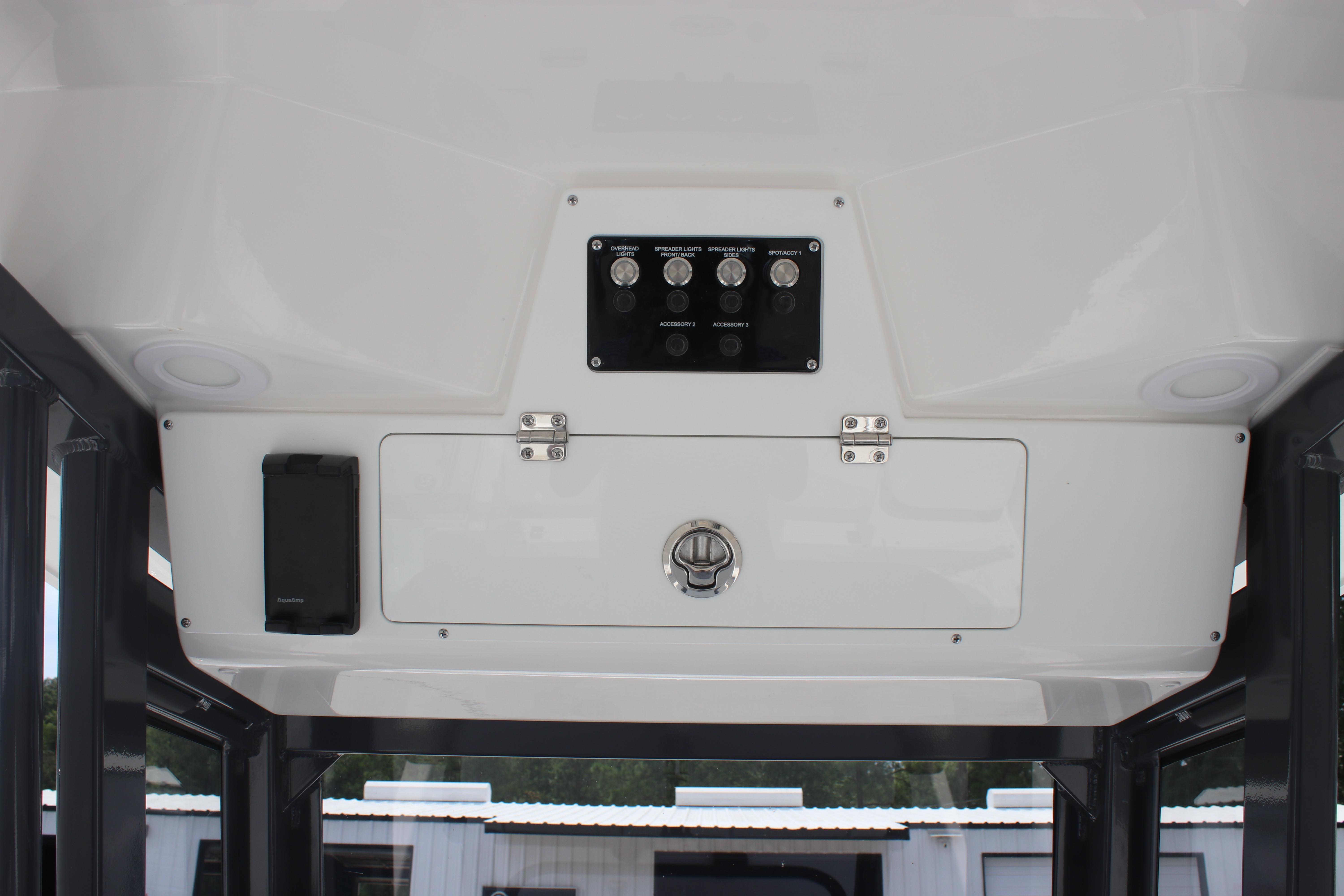 Interior view of 2026 Sea Fox 248 Commander boat's control panel and storage compartment.