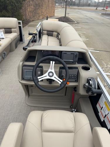 2025 Sun Tracker SportFish 22 DLX boat interior with steering wheel and control panel.