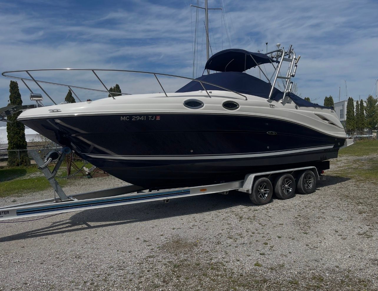 2006 Sea Ray 270 Amberjack on trailer outdoors.
