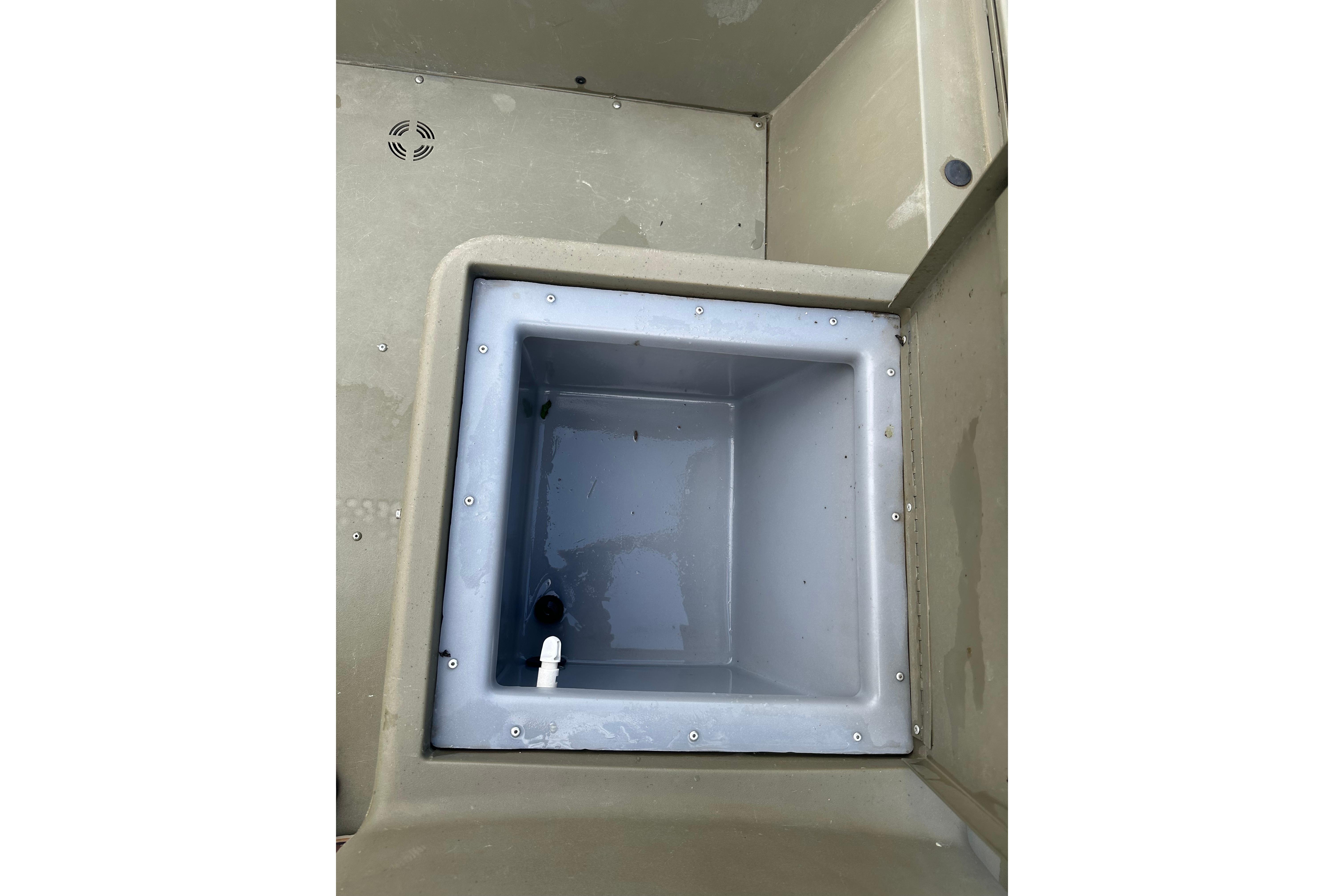 2024 Tracker Grizzly 1648 SC boat interior showing a built-in storage compartment.