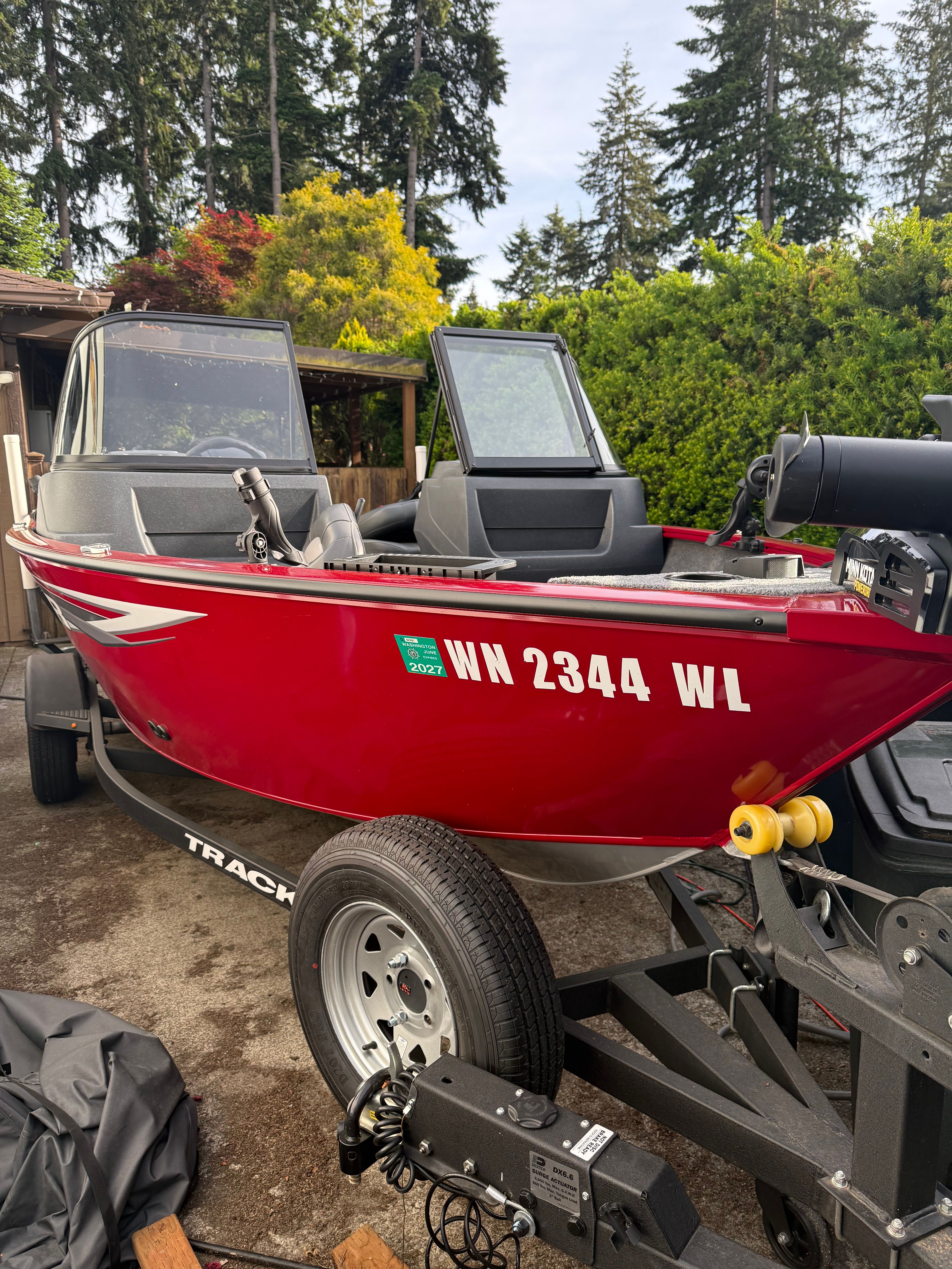 Red 2025 Tracker Pro Guide V-16 WT boat on trailer.
