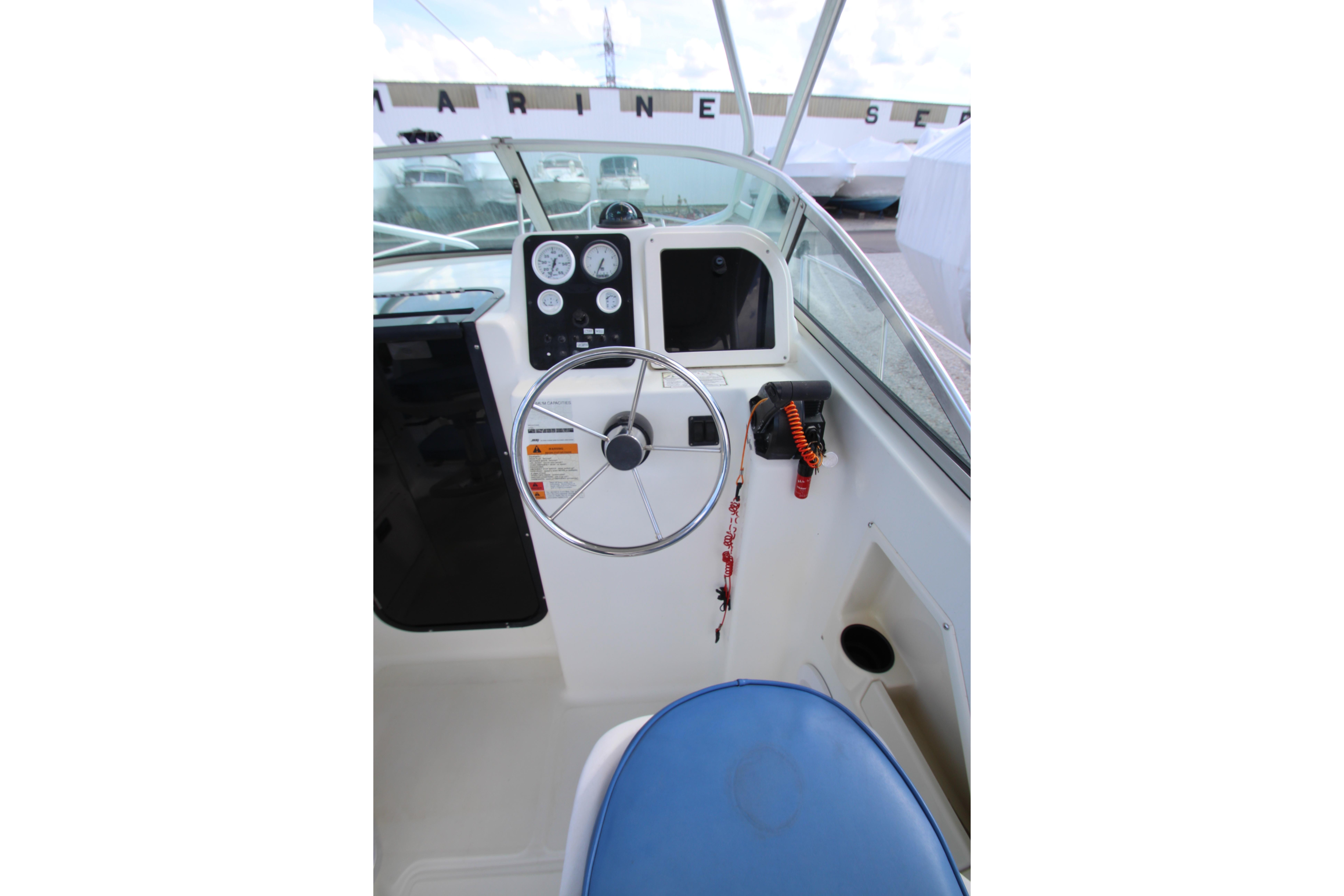 2002 Hydra-Sports 230 WA boat cockpit with steering wheel and instrument panel.