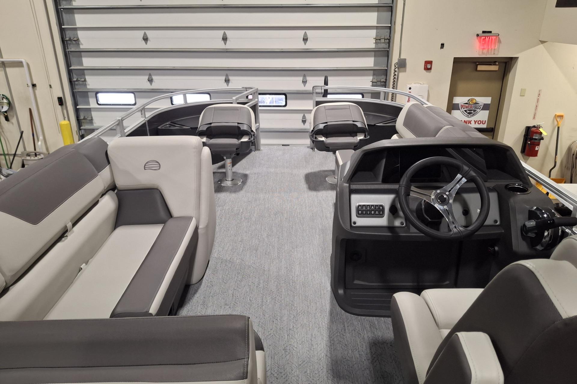 2026 Sun Tracker Party Barge 20 DLX interior with seating and steering console.