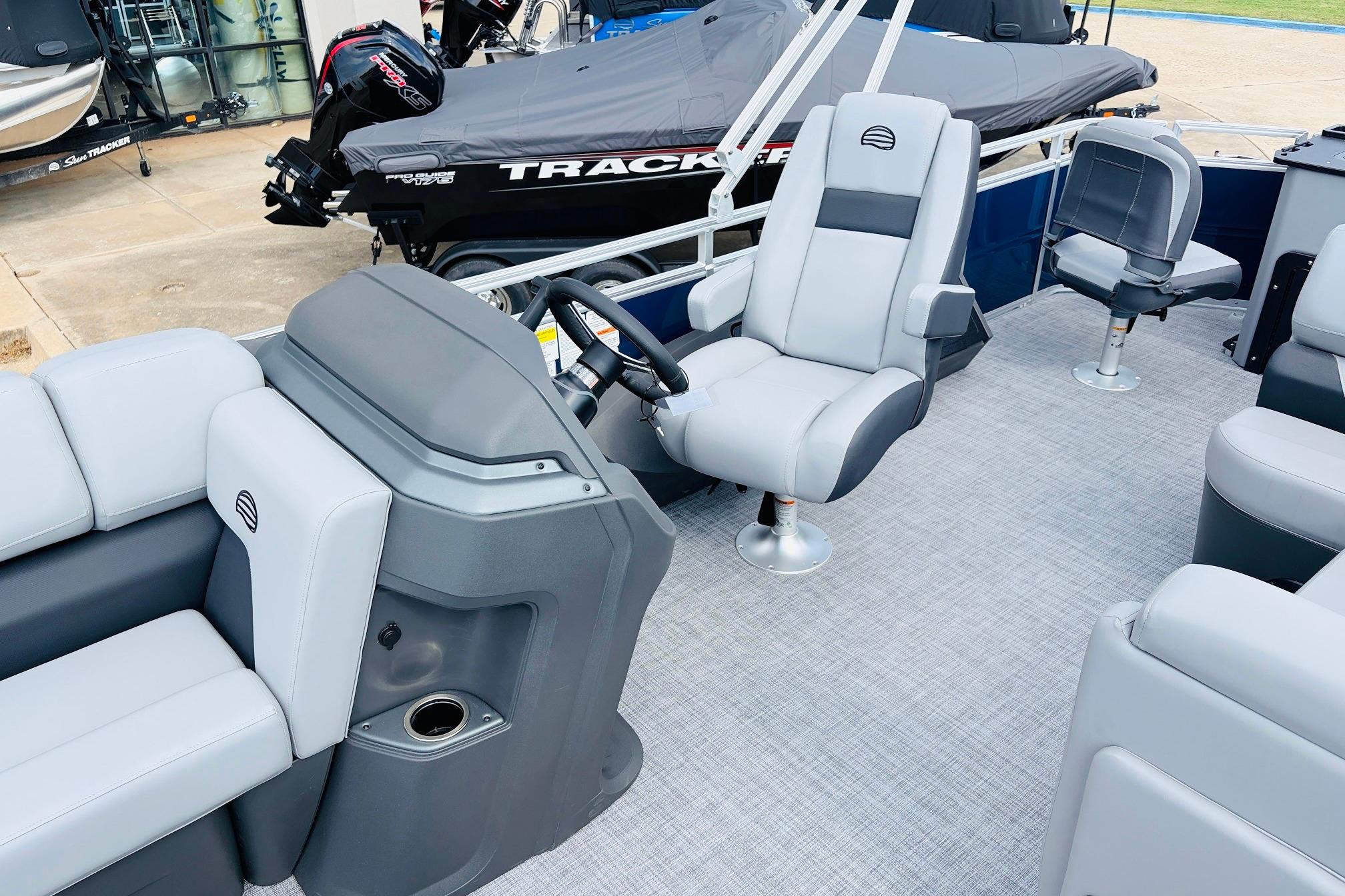 2026 Sun Tracker SportFish 22 DLX boat interior with gray seating and steering console.