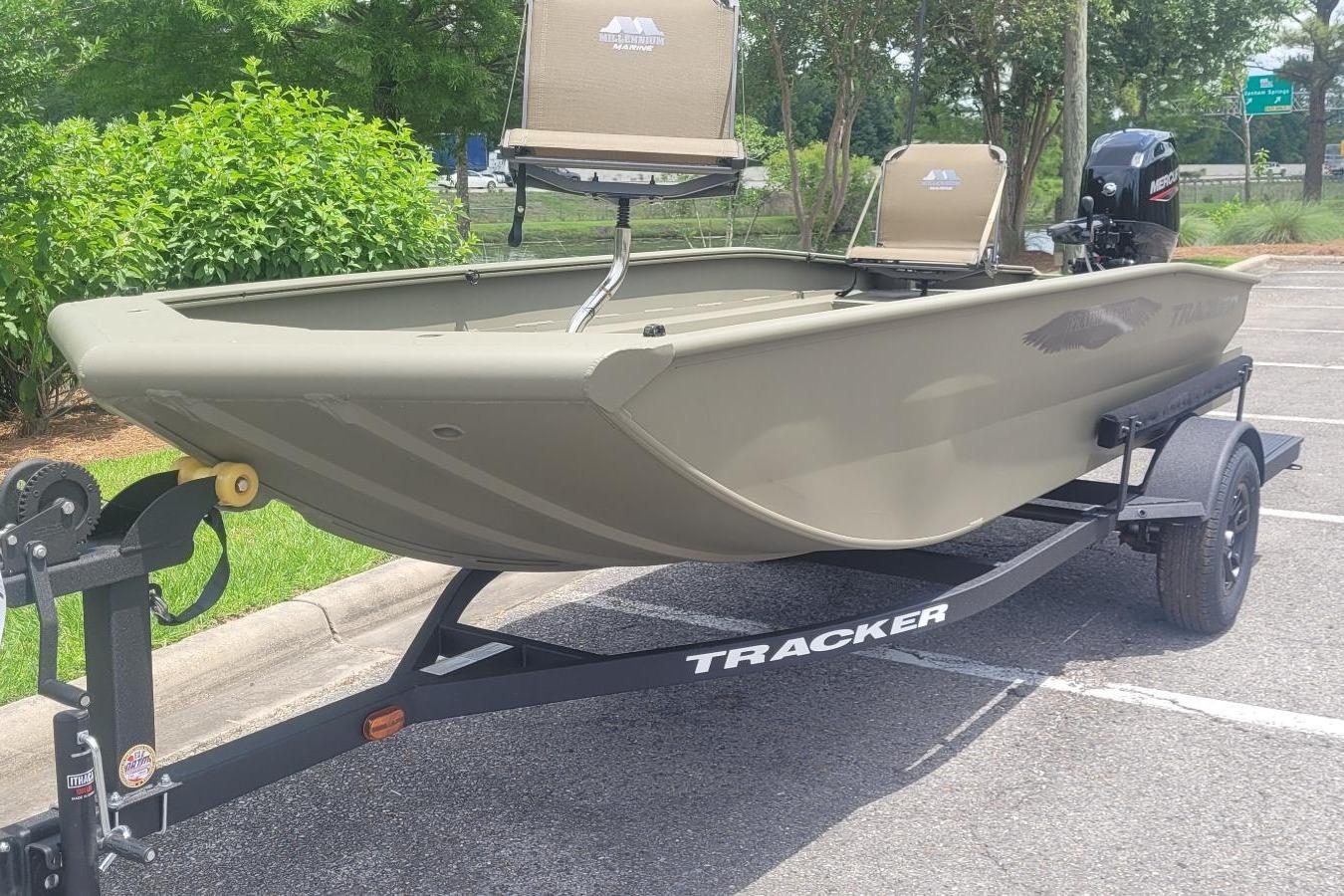 2026 Tracker Grizzly 1650 T Prairie Wings Edition boat on trailer in parking lot.