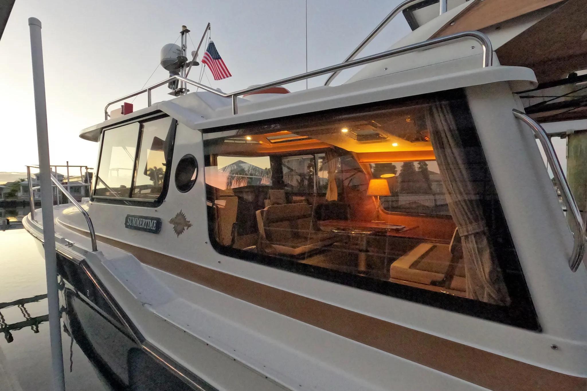 2015 Ranger Tugs R-29 S boat docked at sunset, interior warmly lit.