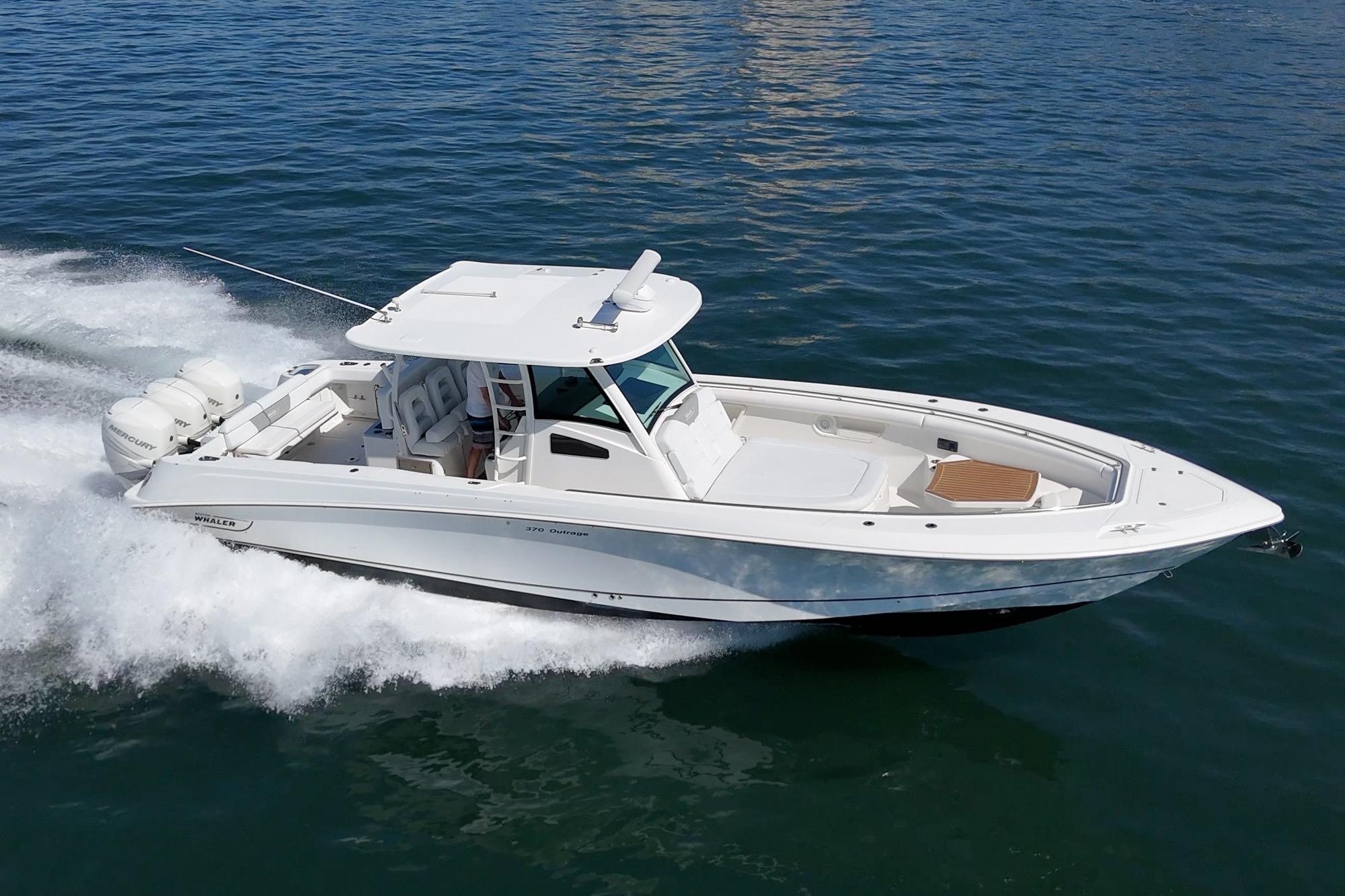 2015 Boston Whaler 370 Outrage cruising on open water, showcasing sleek design and powerful engines.