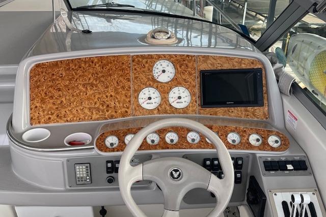 1999 Formula 400 Super Sport boat dashboard with wood paneling and modern gauges.