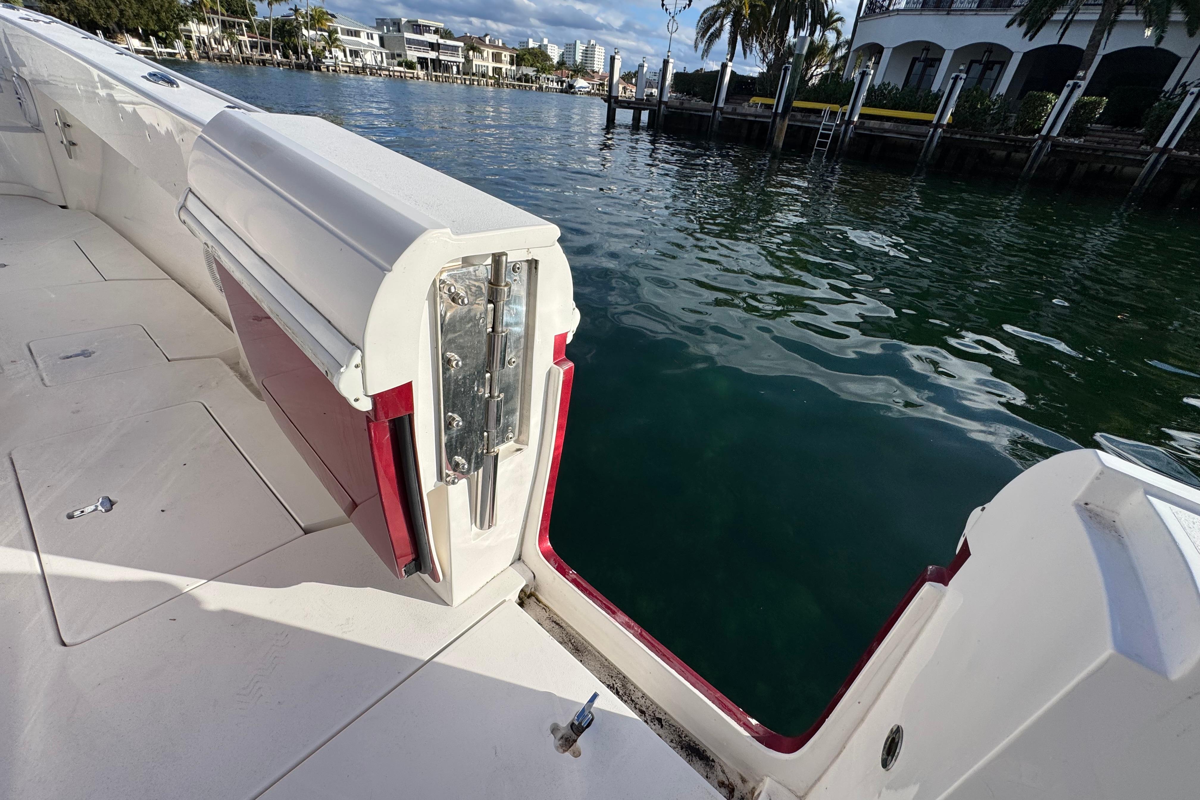 2017 Intrepid 375 Center Console boat with open side door, dockside view.