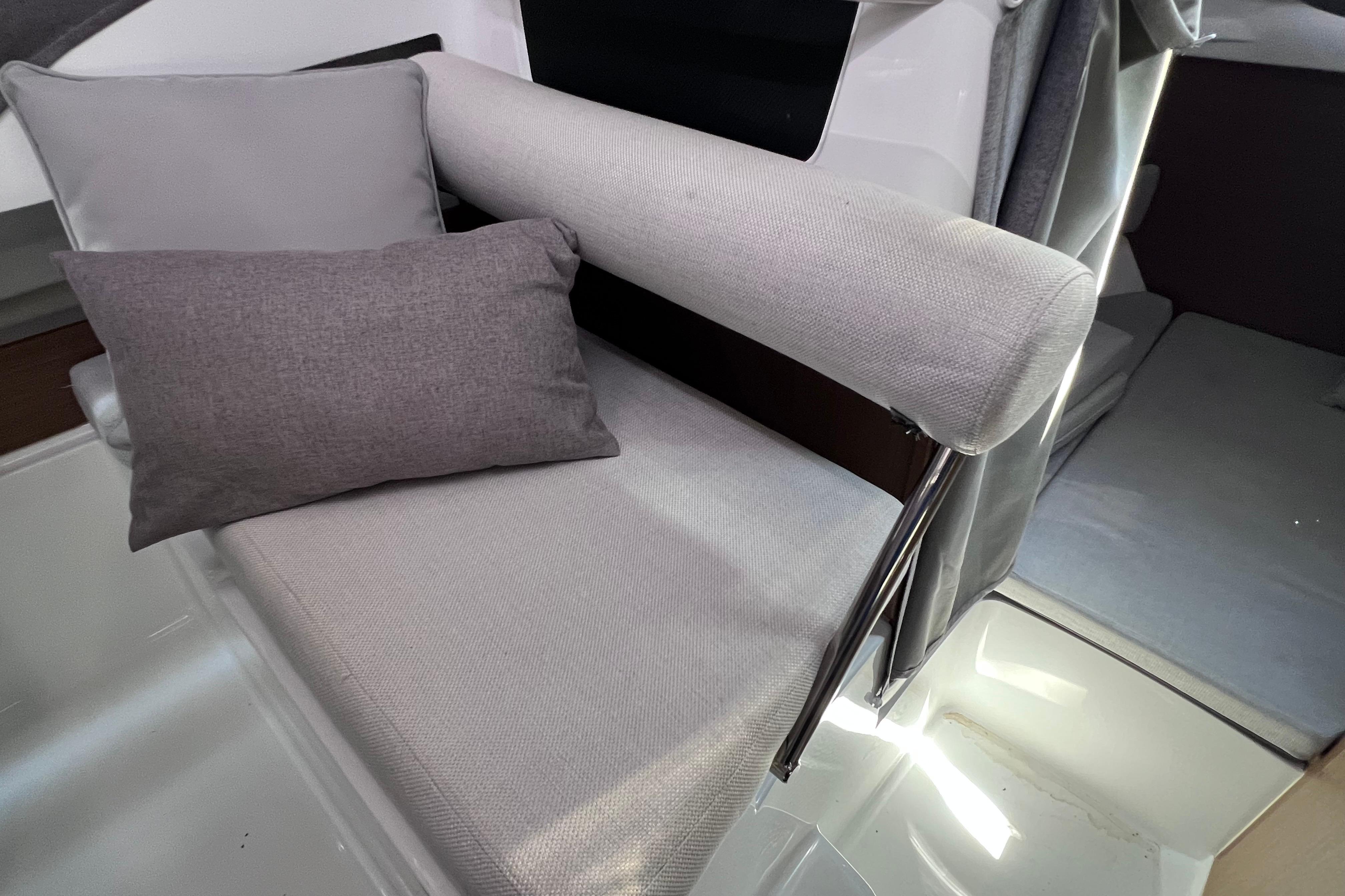 Interior seating of 2021 Jeanneau NC Weekender 795 Series 2 with gray cushions.