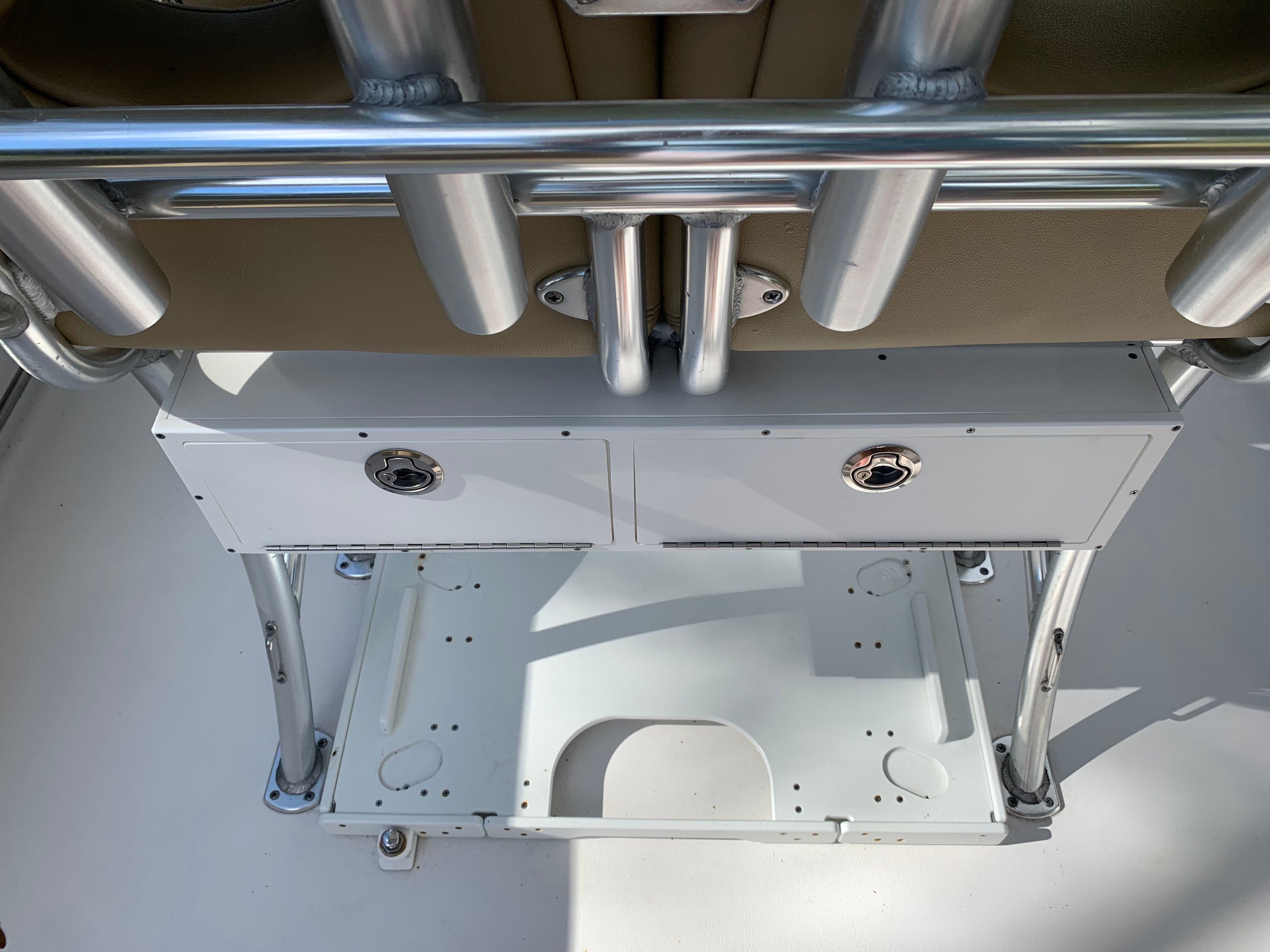 Close-up of a boat console with stainless steel fittings and storage space.