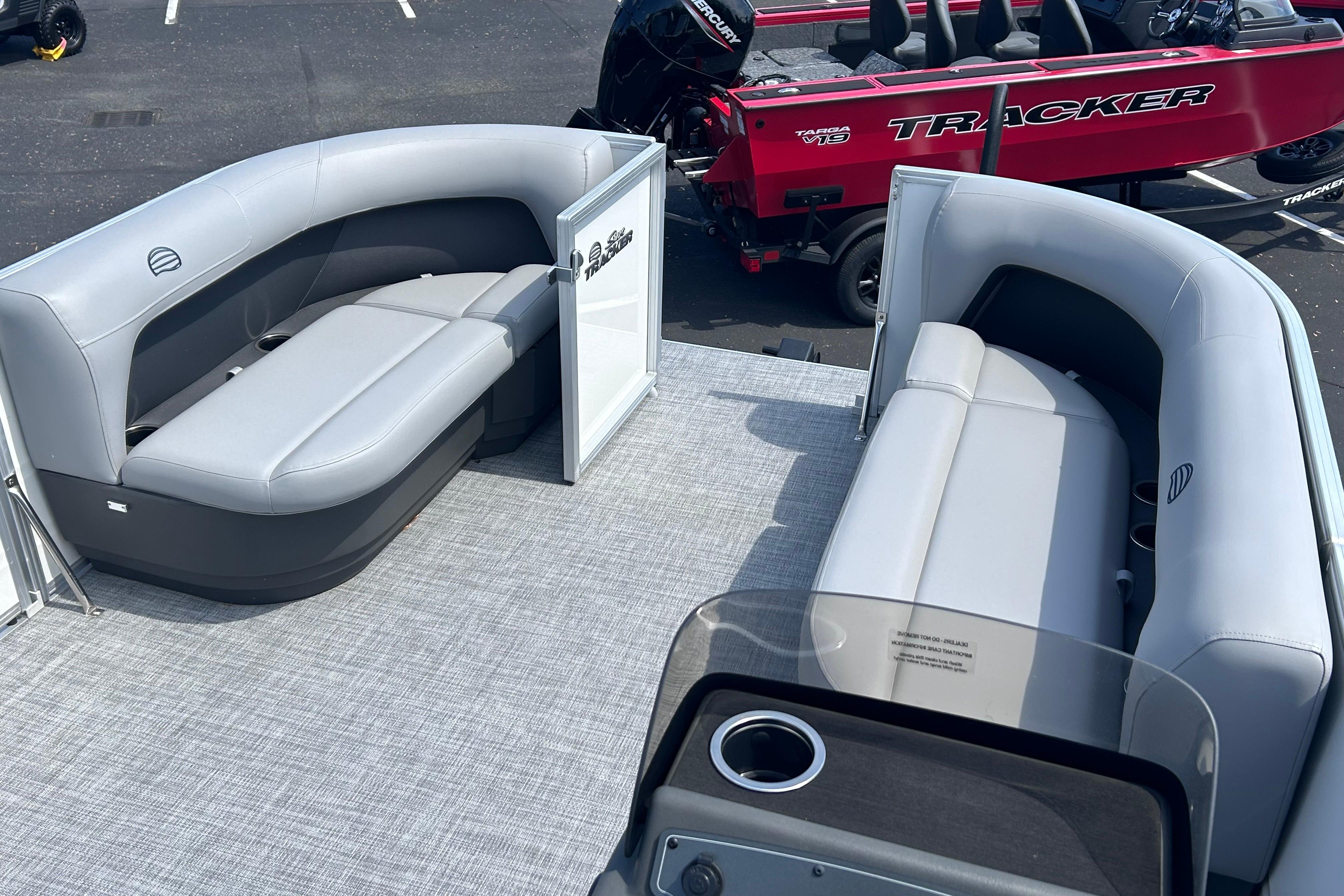 2026 Sun Tracker Party Barge 16 DLX with gray seating and spacious deck layout.