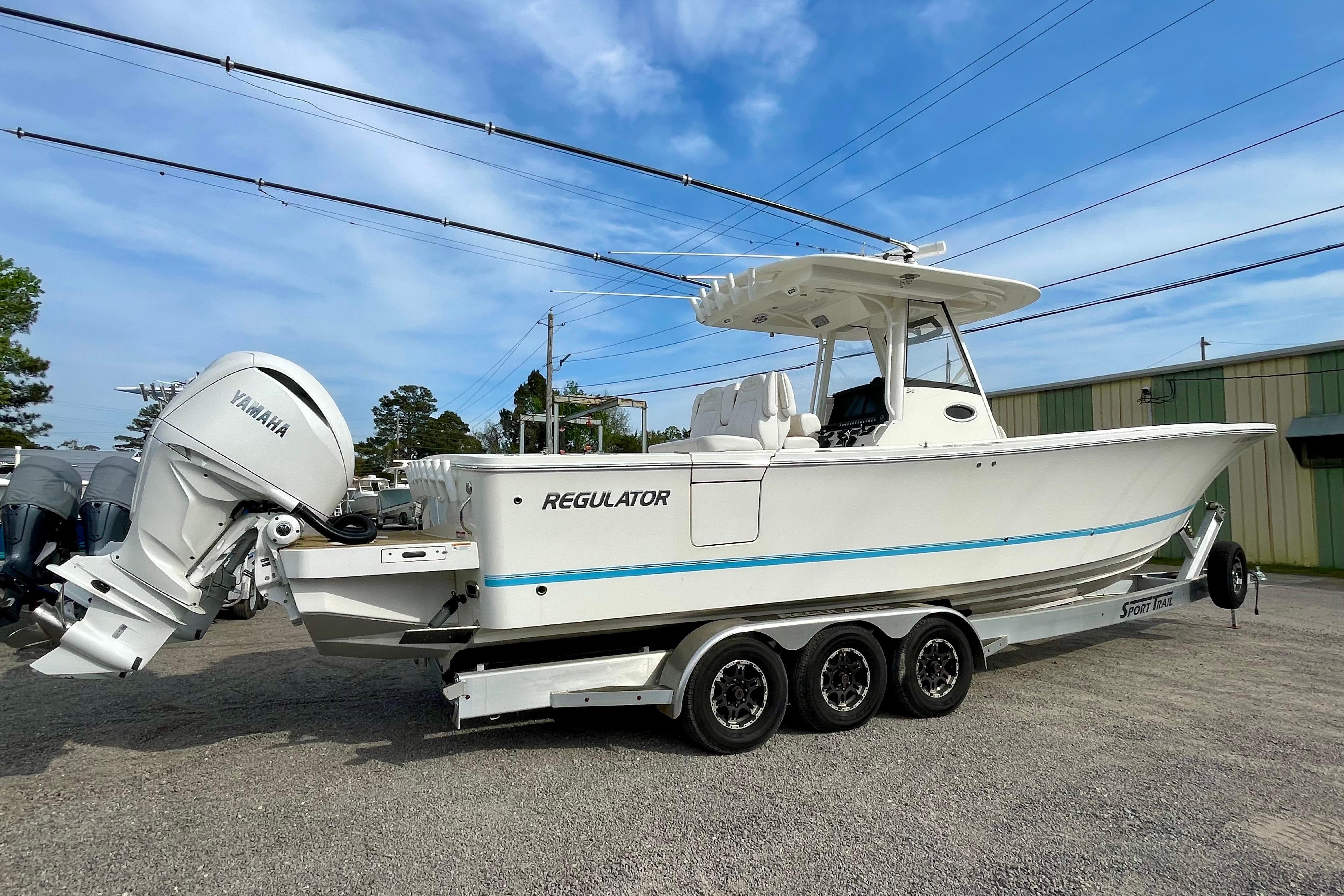 2023 Regulator 34 boat with Yamaha engines on a trailer, parked outdoors.
