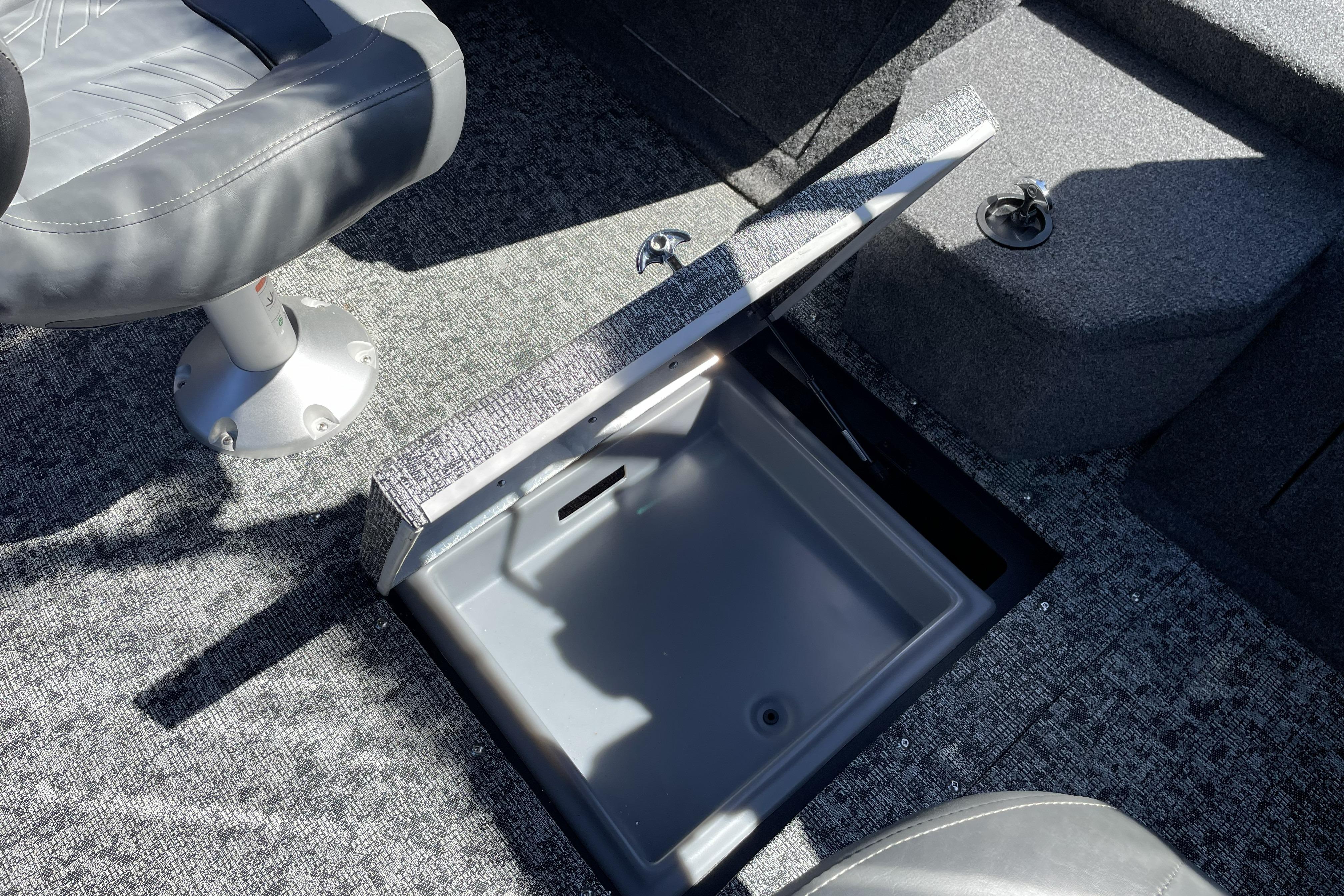 2026 Tracker Targa V-18 WT boat interior with open storage compartment and seating.