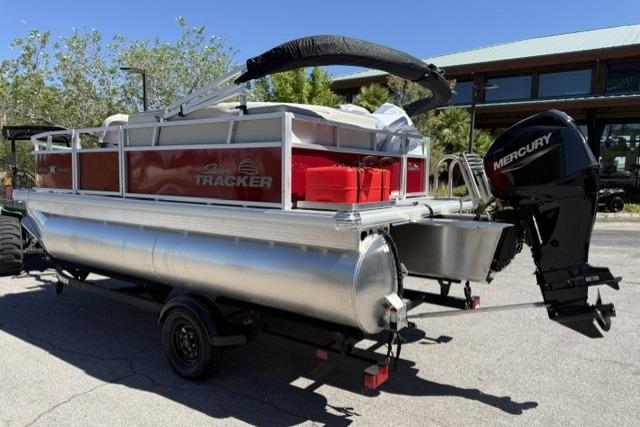 2026 Sun Tracker Bass Buggy 16 XL Select pontoon boat with Mercury outboard motor on trailer.