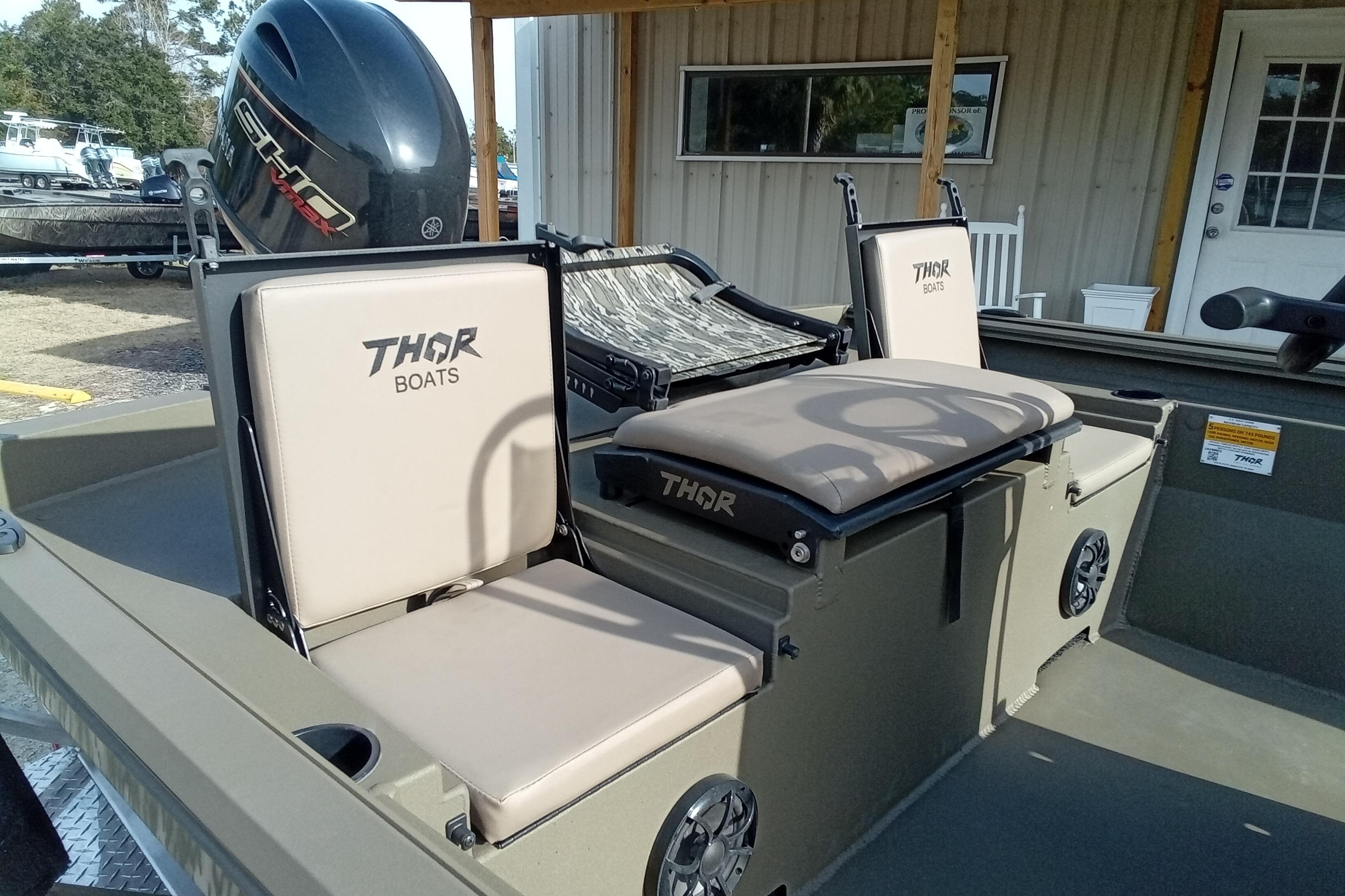 2026 Thor 1900 Low Country Elite boat with cushioned seats and motor.