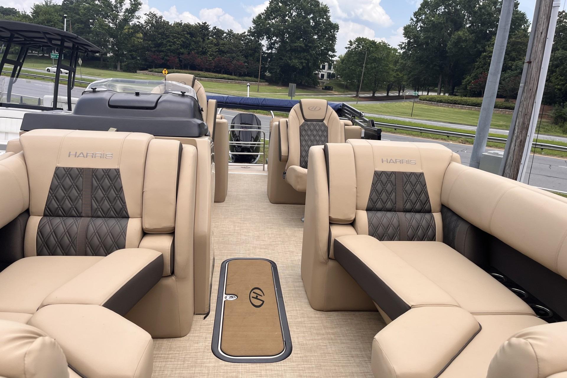 Luxurious interior of 2022 Harris Solstice 230 CWDH pontoon boat with plush seating.