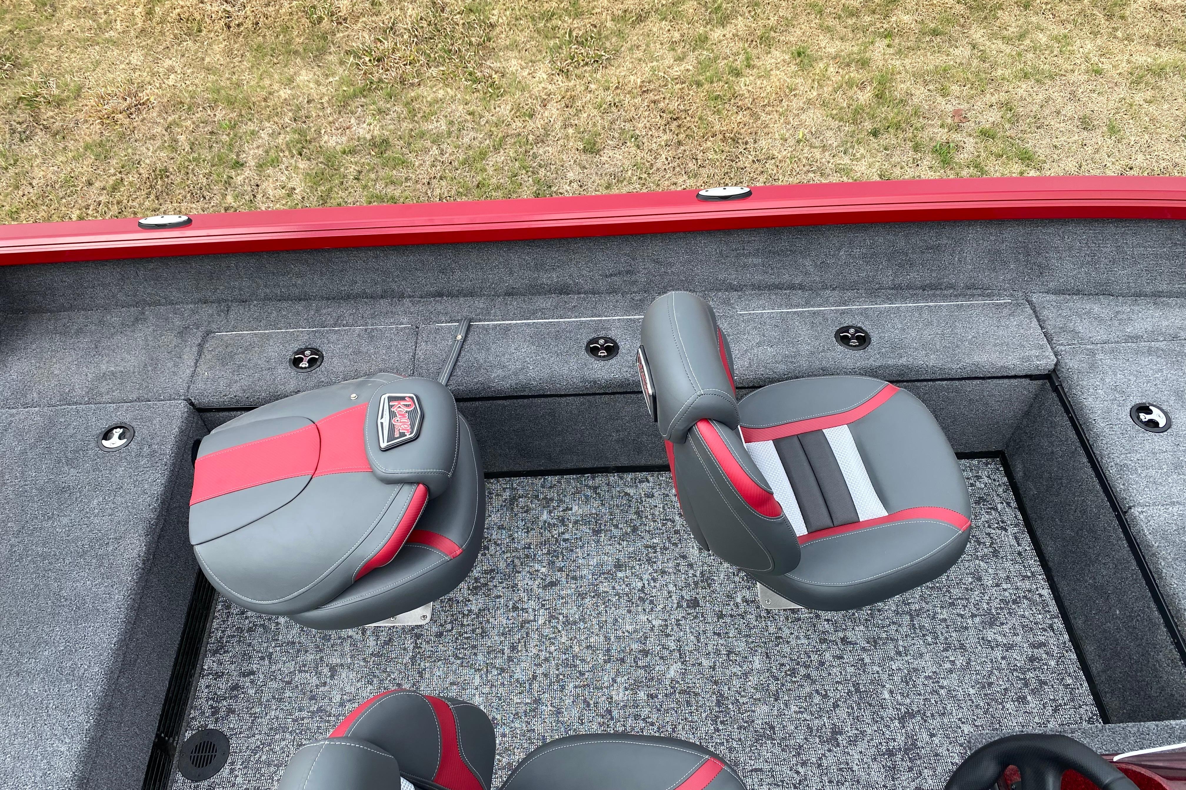 2026 Ranger VS1665SC boat interior with red and gray seating on a grassy background.