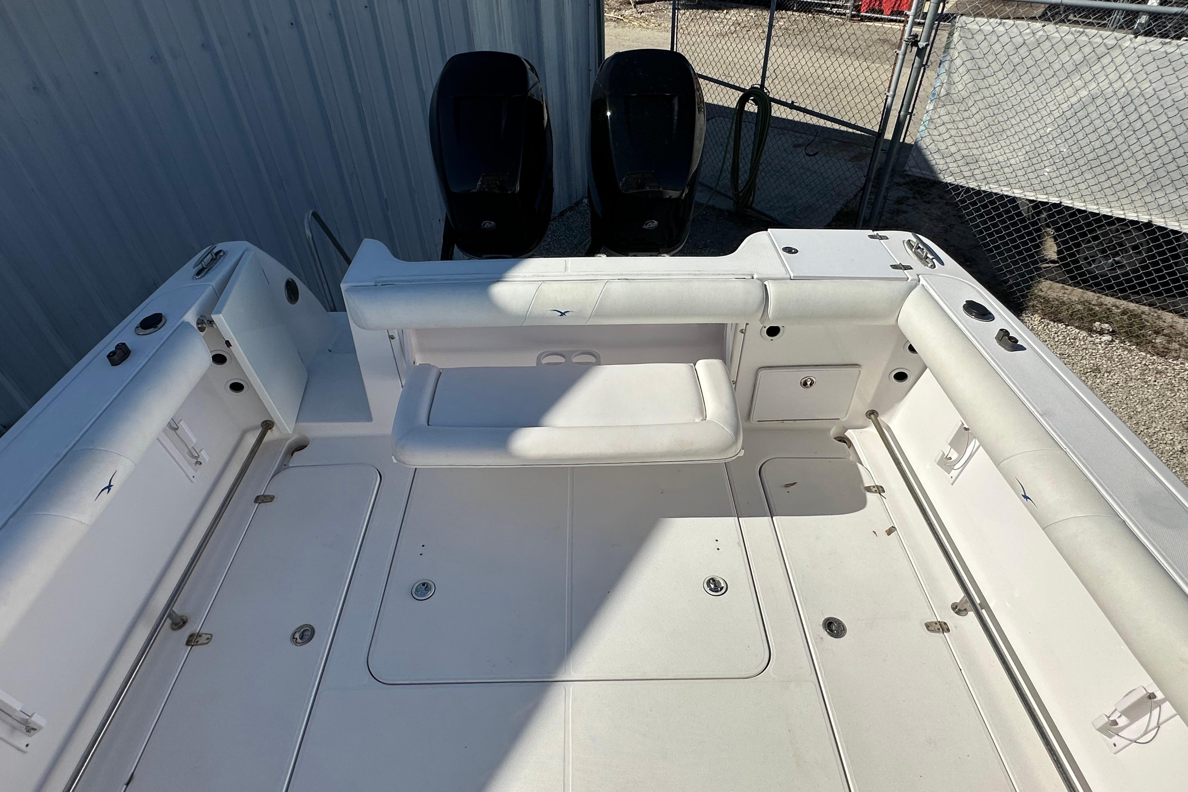 2006 Pro-Line 32 Express boat deck with seating and dual outboard motors.