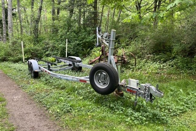 2008 E-Z-Loader boat trailer in a lush, wooded area.