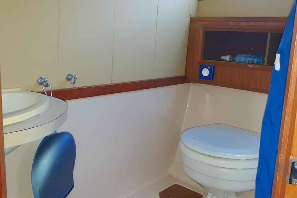 Bathroom interior of 1989 Fairey Spearfish MKIII boat with sink and toilet.