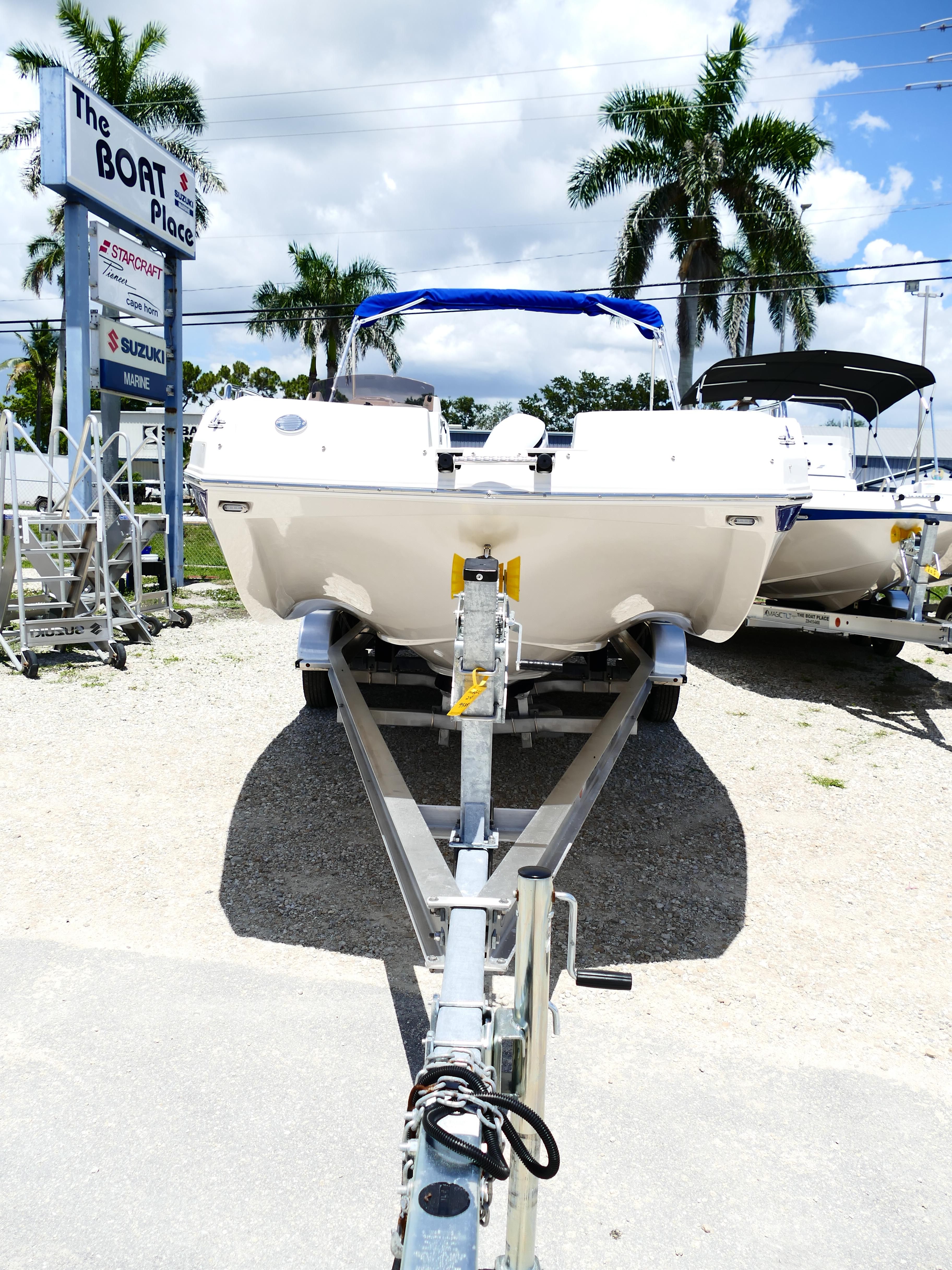 2026 Starcraft SVX 231 OB DH boat on trailer at dealership, sunny day.