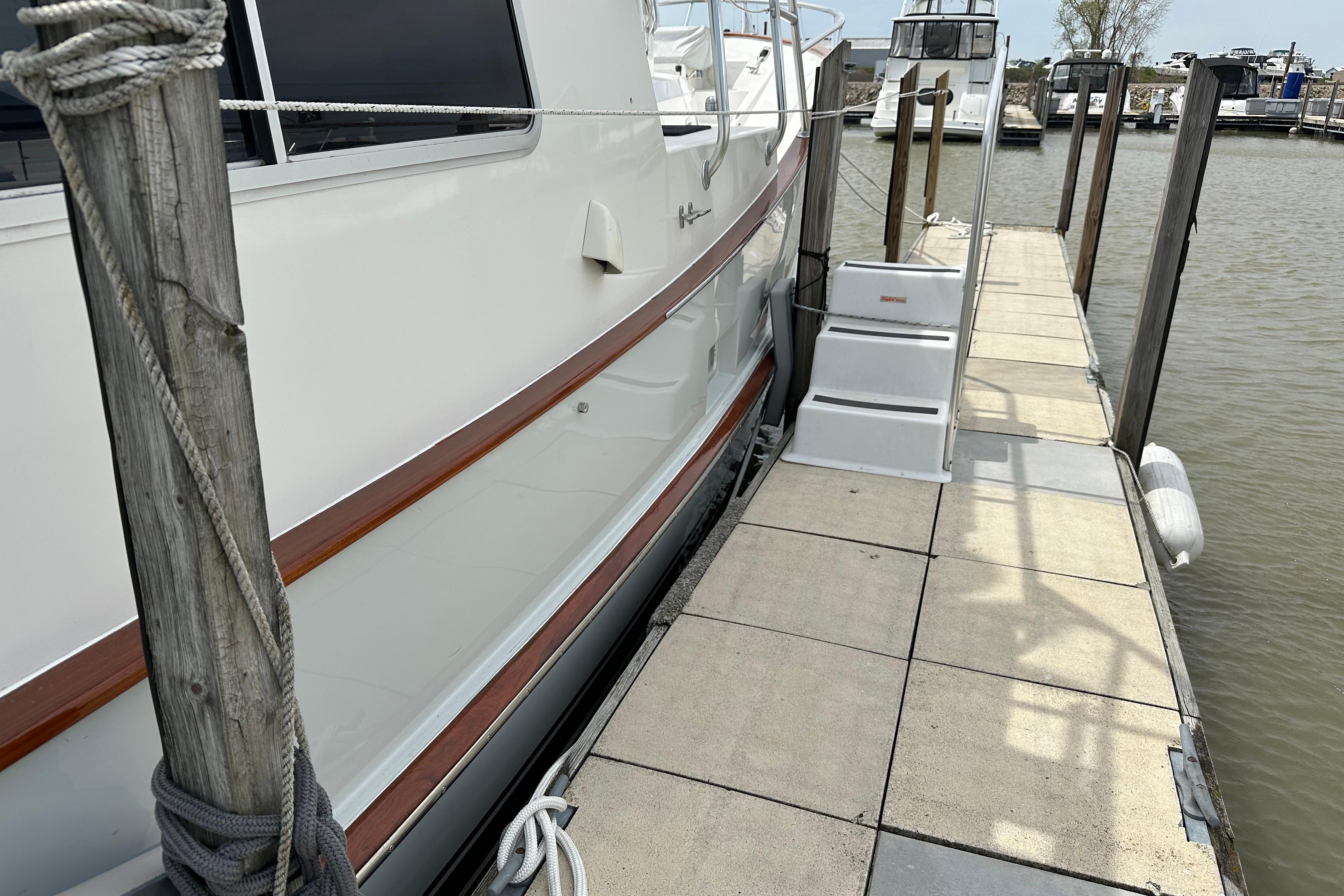 Cherubini Independence 45 yacht docked, showcasing sleek design and elegant wood accents, 2001 model.