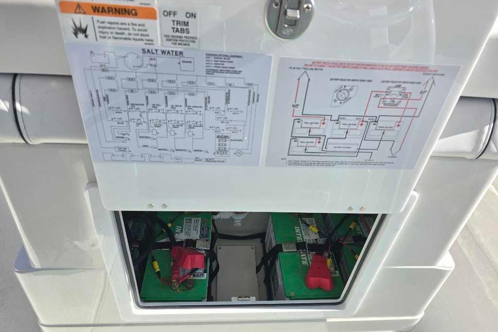 Battery compartment of 2025 Ranger 2510 Bay boat with wiring diagrams and warning labels.