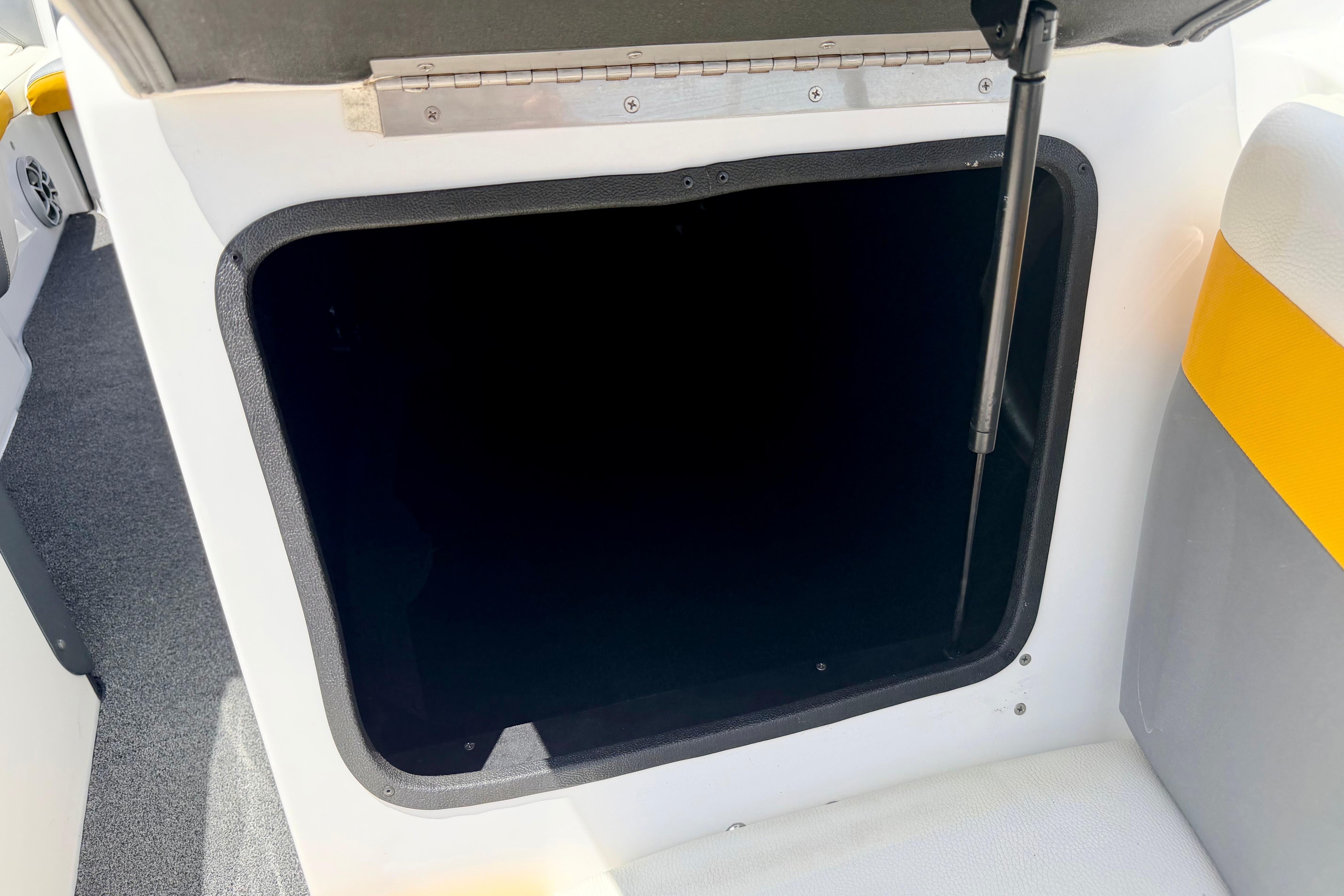 Open storage compartment in 2014 Tigé R20 boat interior.