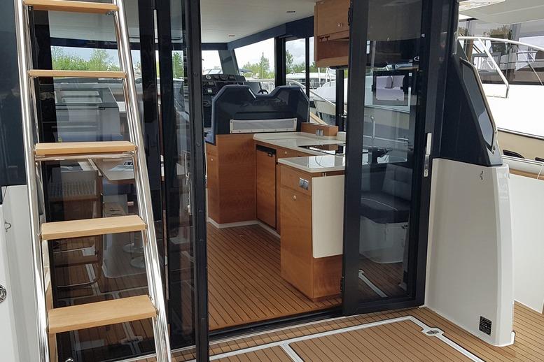 Interior view of 2019 Delphia BluEscape 1200 yacht with wooden flooring and modern kitchen.