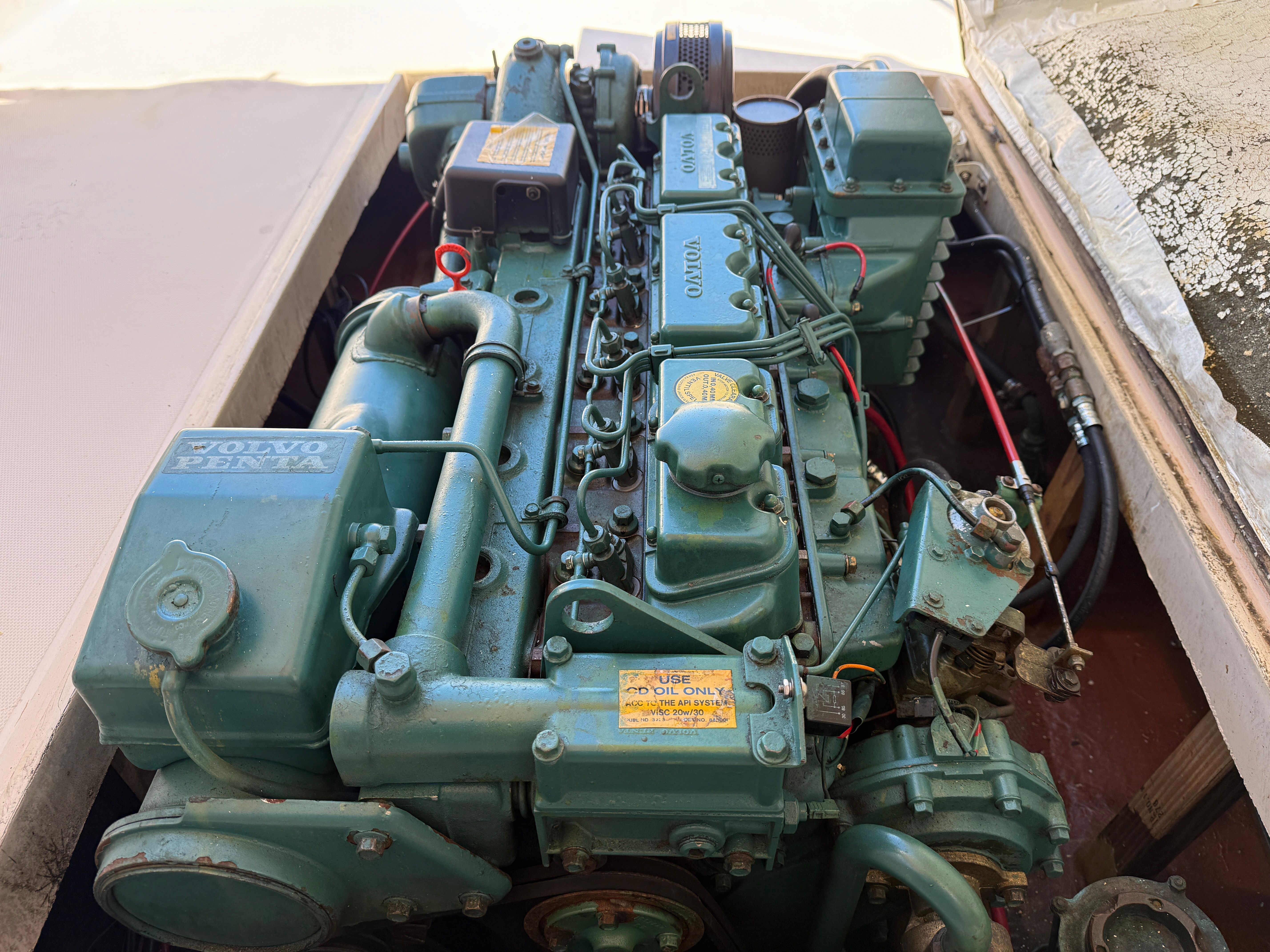 A Volvo Penta engine in a boat, partially surrounded by a cover.