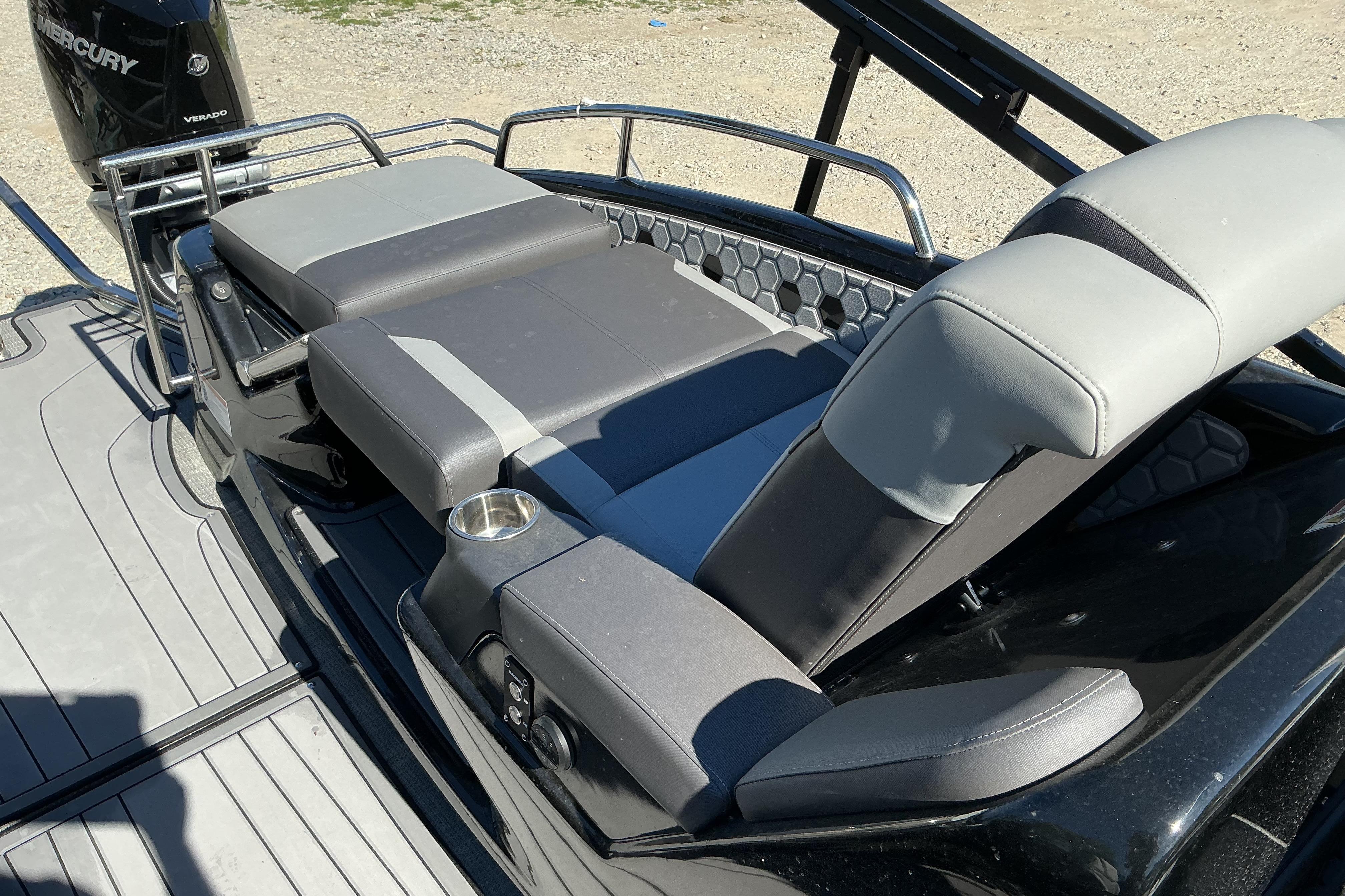 2024 Manitou 25 X-Plode XT SRS boat interior with adjustable seating and cup holder.