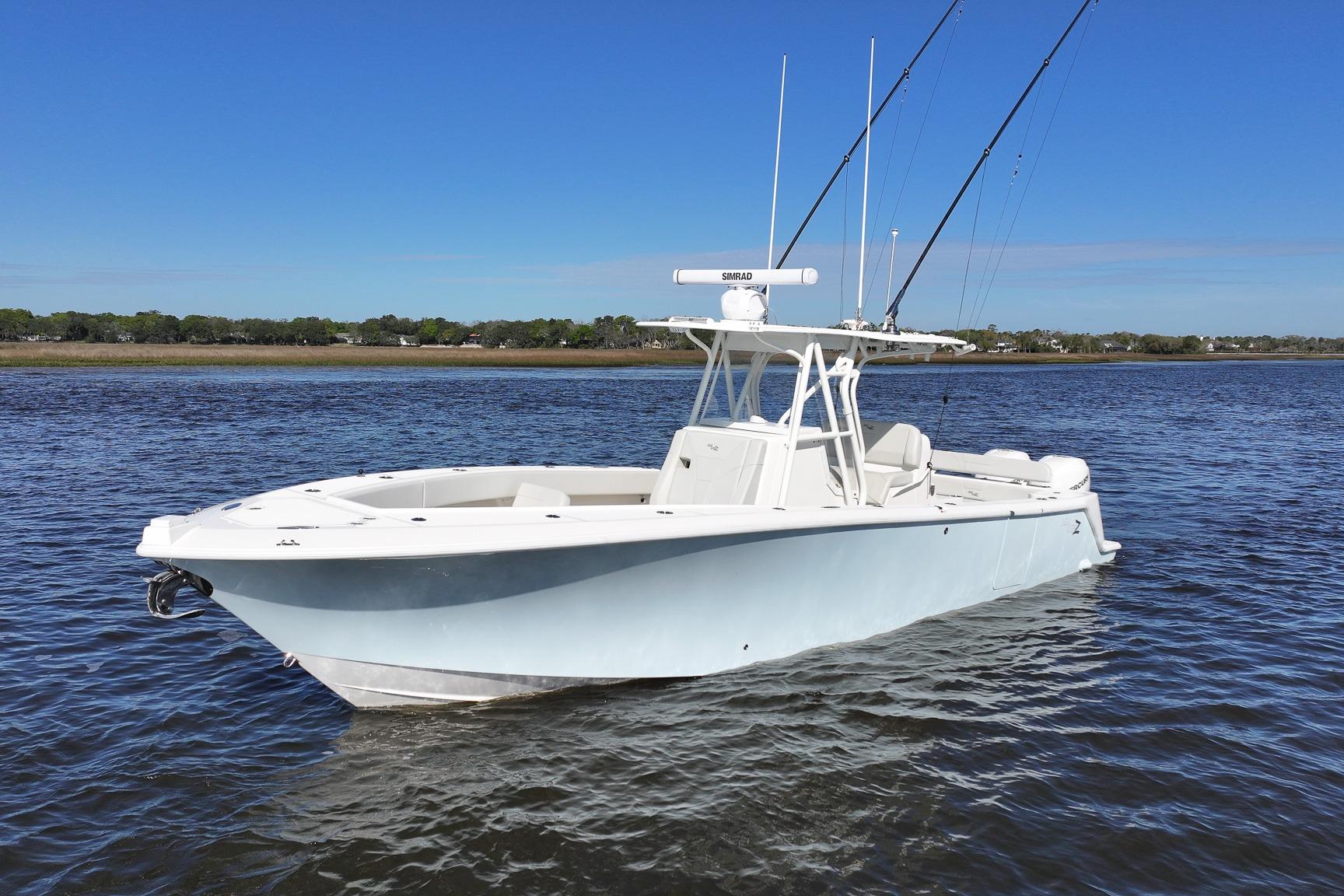 2022 SeaVee 322Z boat on calm water under clear blue sky.