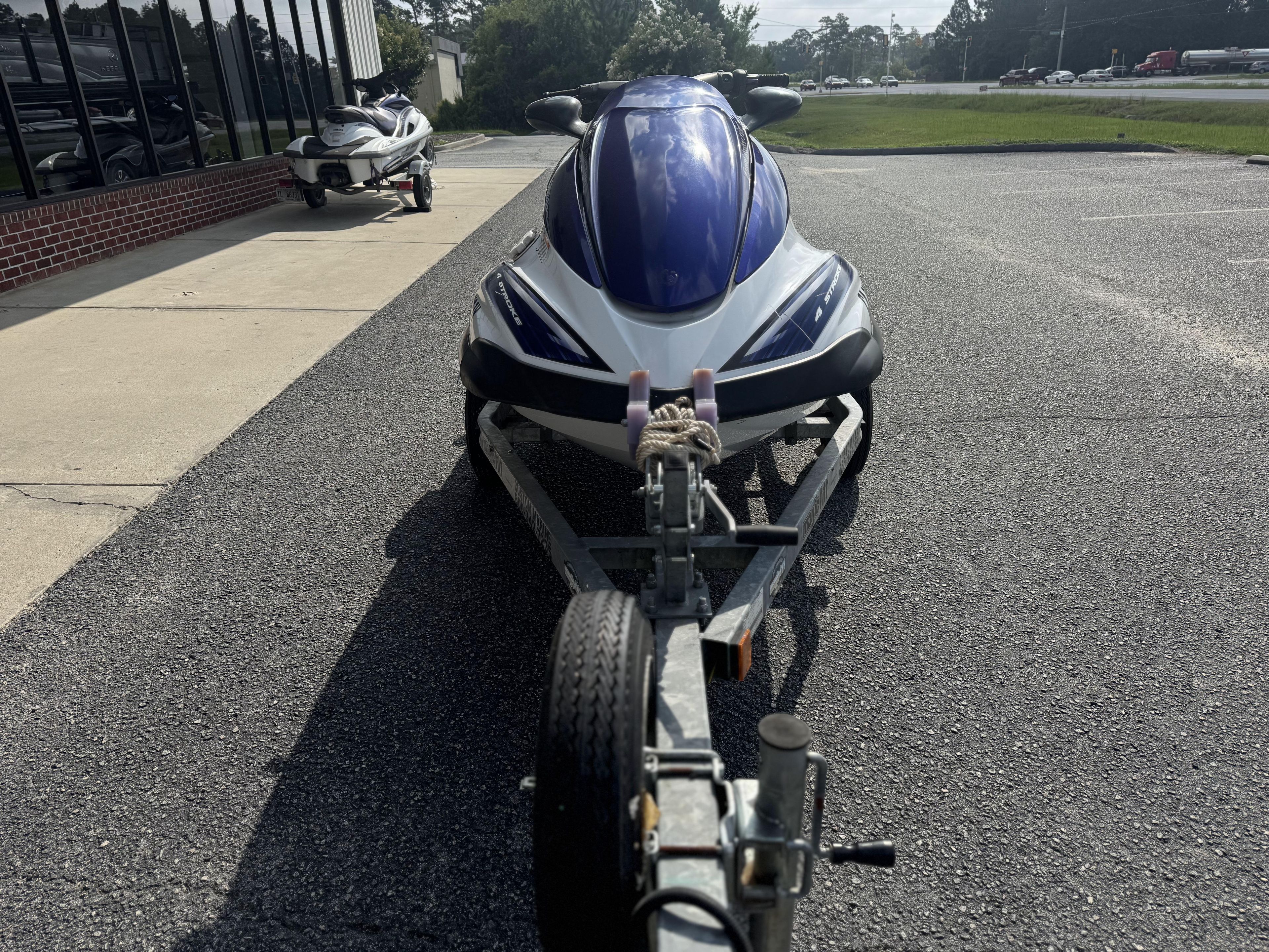 2003 Yamaha WaveRunner FX140 on trailer in parking lot.