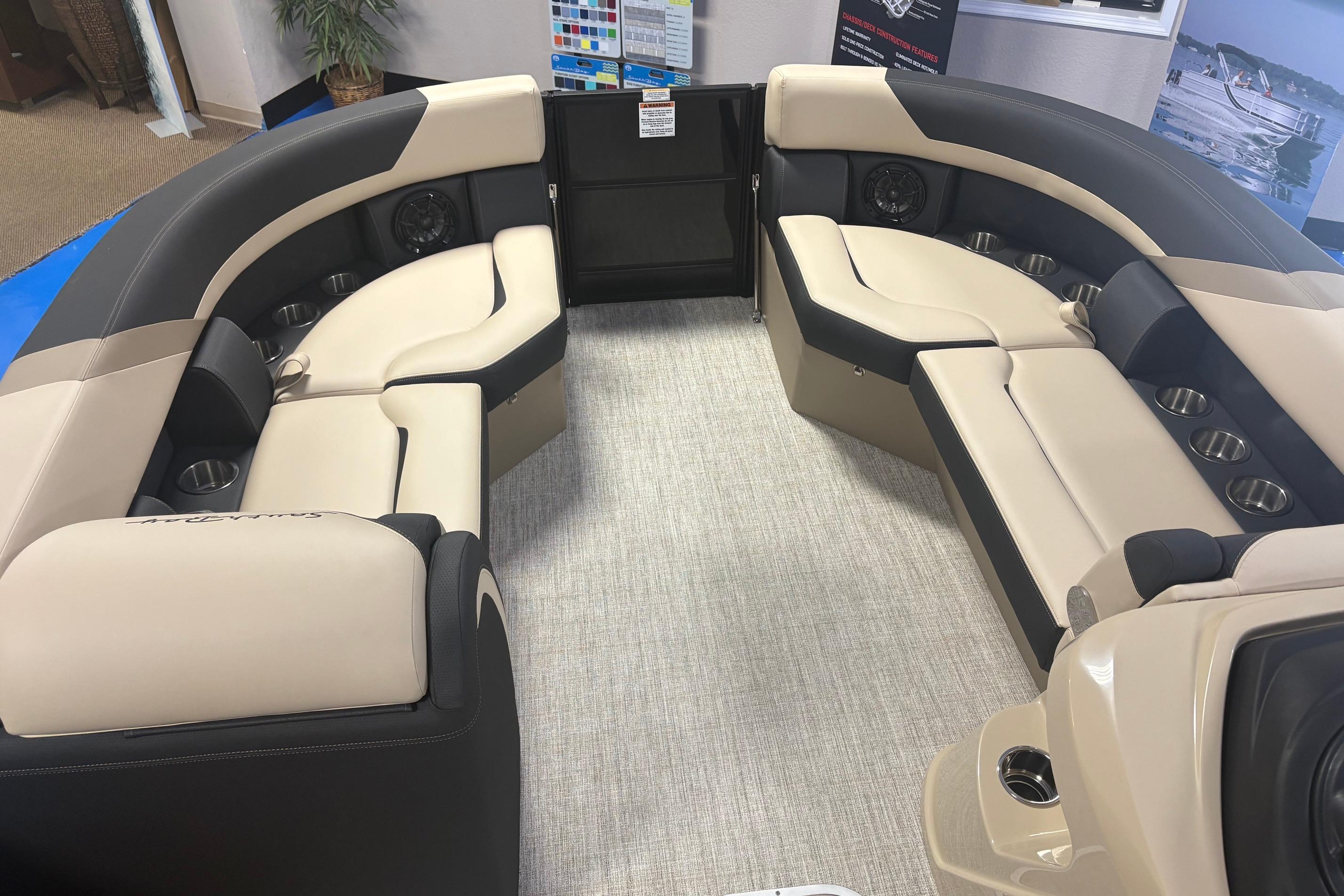 Luxurious interior of 2026 South Bay S224RS pontoon boat with plush seating and cup holders.