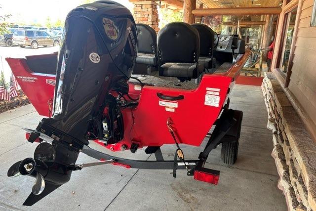 2026 Tracker Pro Guide V-16 SC boat in vibrant red, displayed on a trailer.