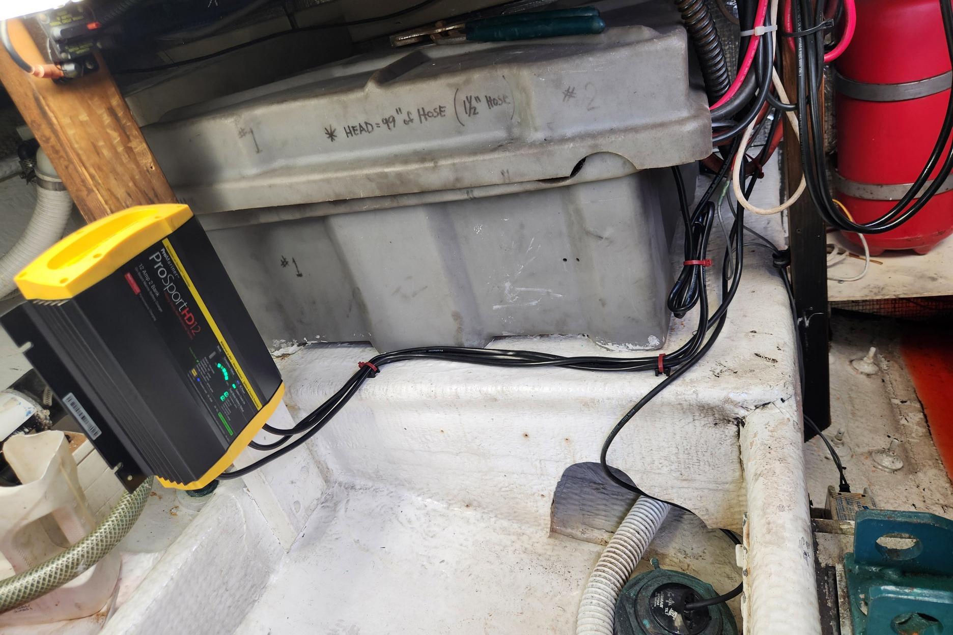 Battery compartment of 1987 Young Brothers Custom Sport Fish with ProSport HD2 charger.